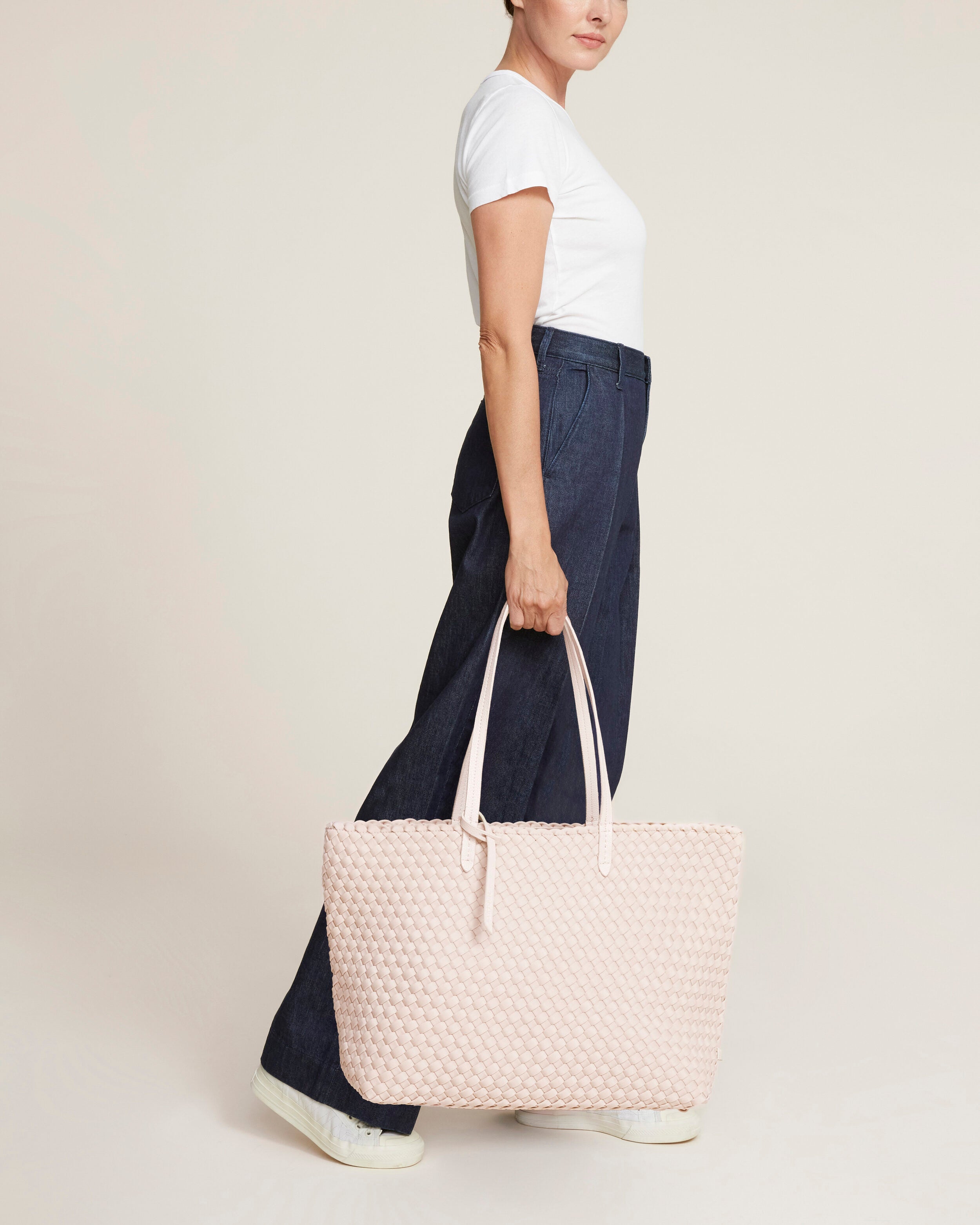 Jetsetter Tote in Shell Pink shown on model to illustrate scale and soft silhouette.