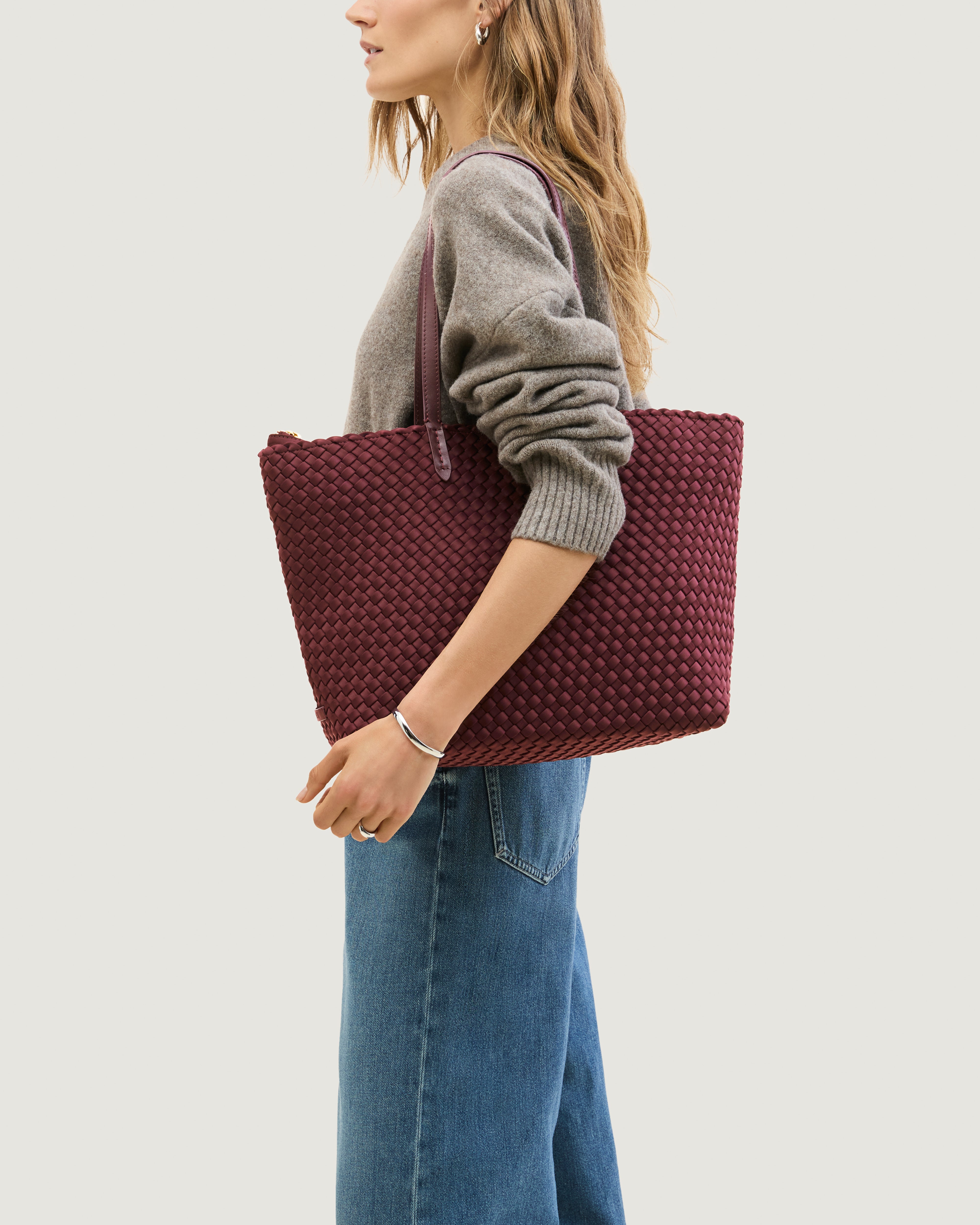 Jetsetter Tote in Bordeaux shown on model to illustrate scale and soft silhouette.