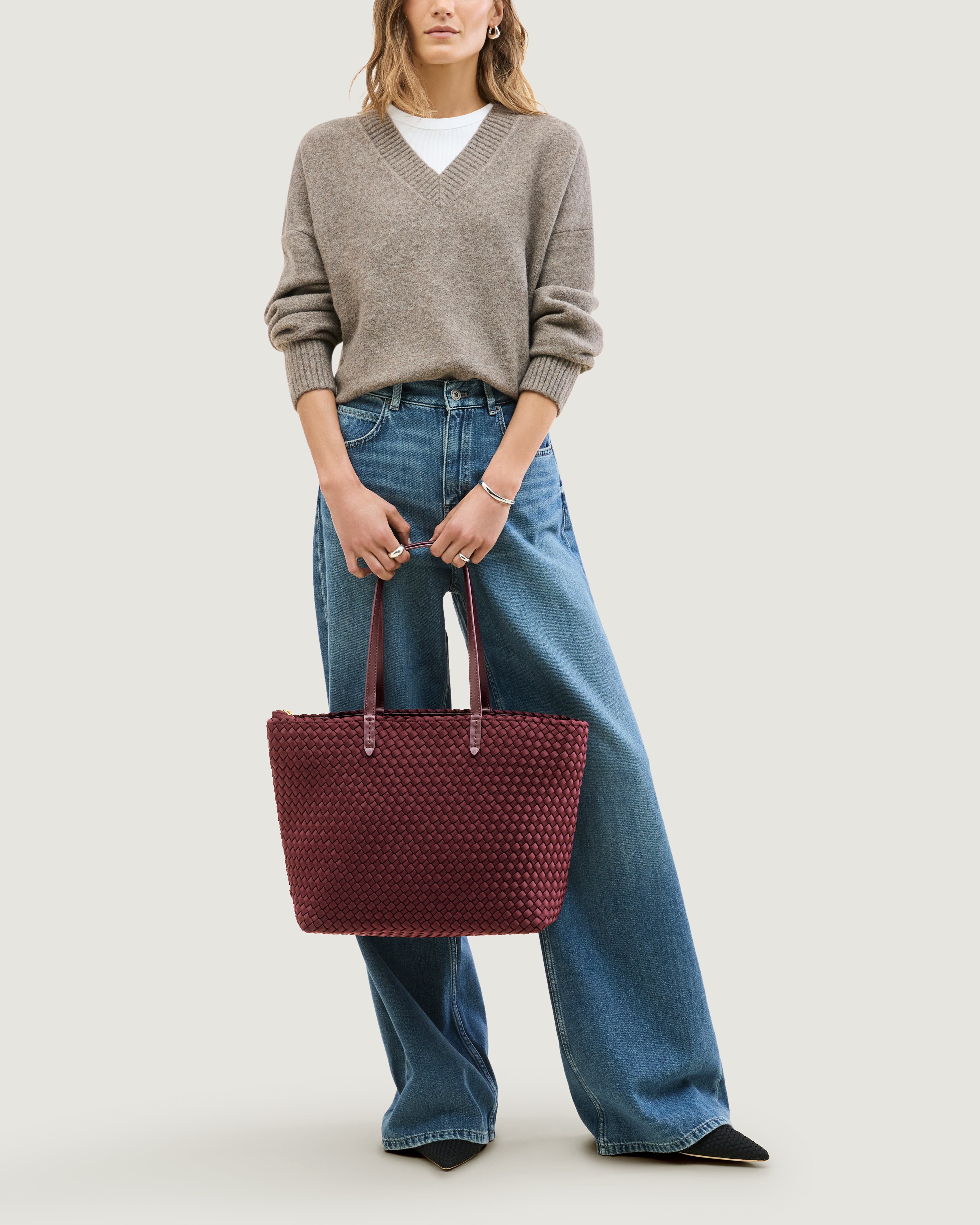 Jetsetter Tote in Bordeaux shown on model to illustrate scale and soft silhouette.