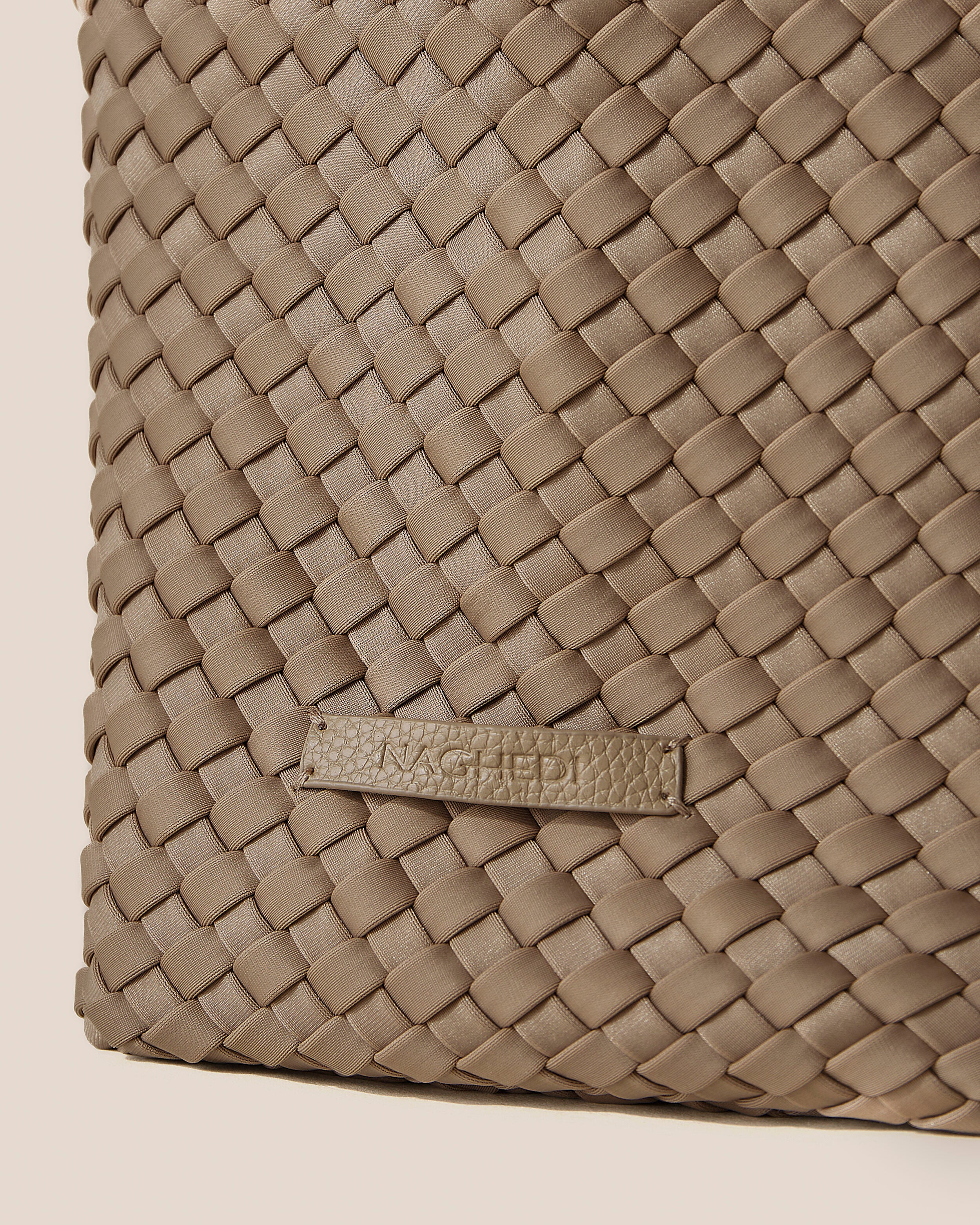 Close-up of stamped NAGHEDI logo on Jetsetter Tote in Cashmere.