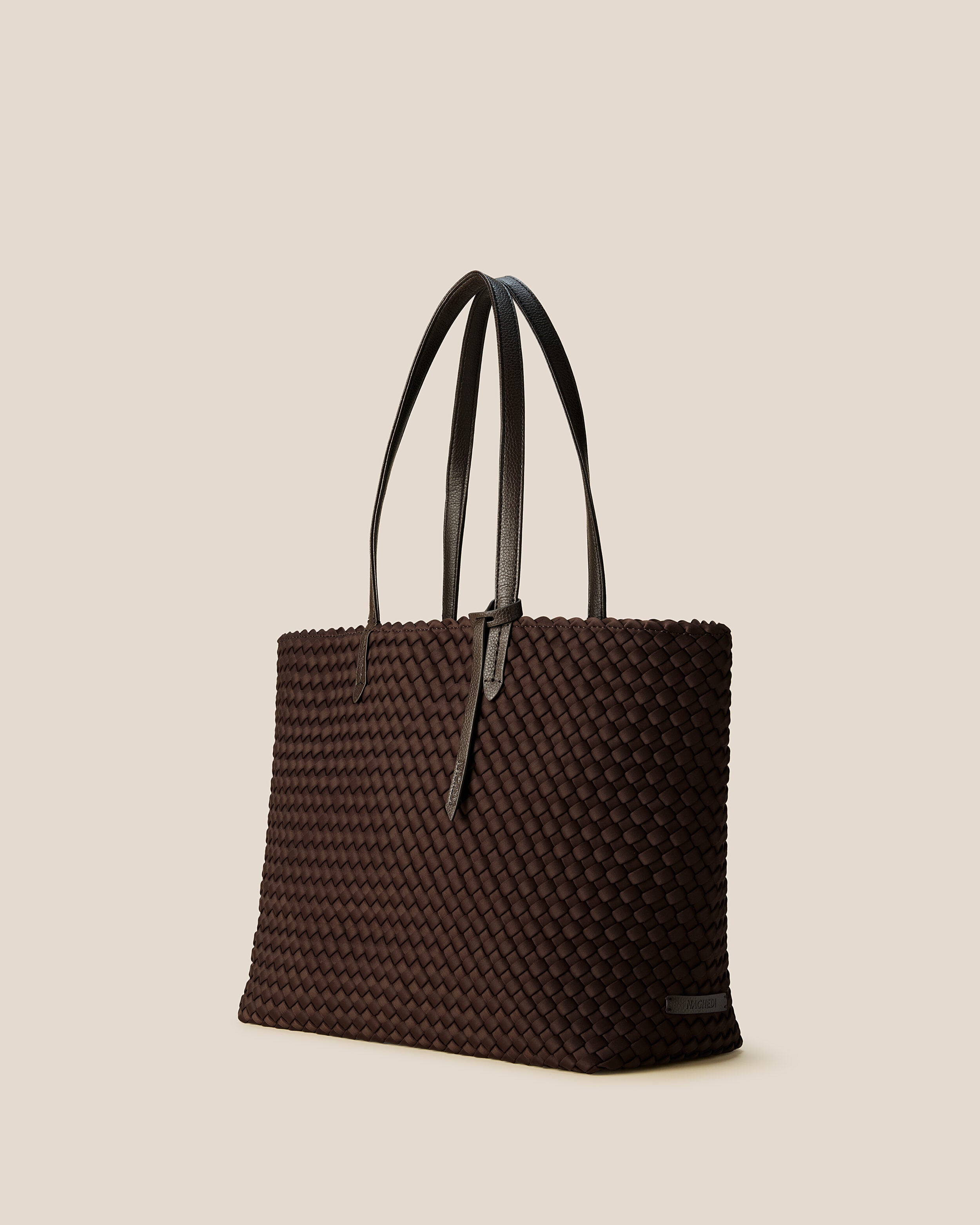 Jetsetter Tote in Chocolate shown from a side angle, highlighting its handwoven neoprene construction and top zip closure.