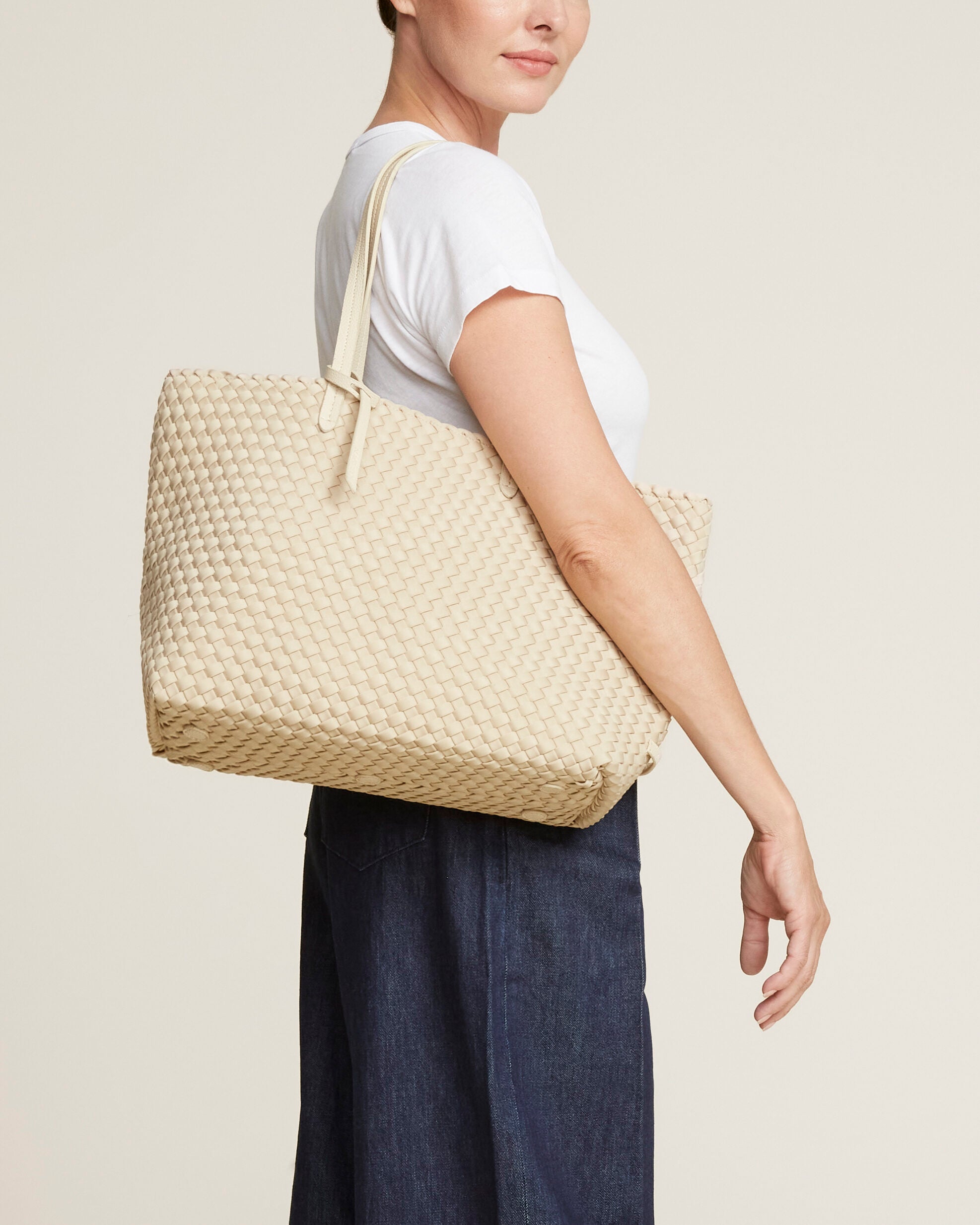 Jetsetter Tote in Ecru shown on model to illustrate scale and soft silhouette.