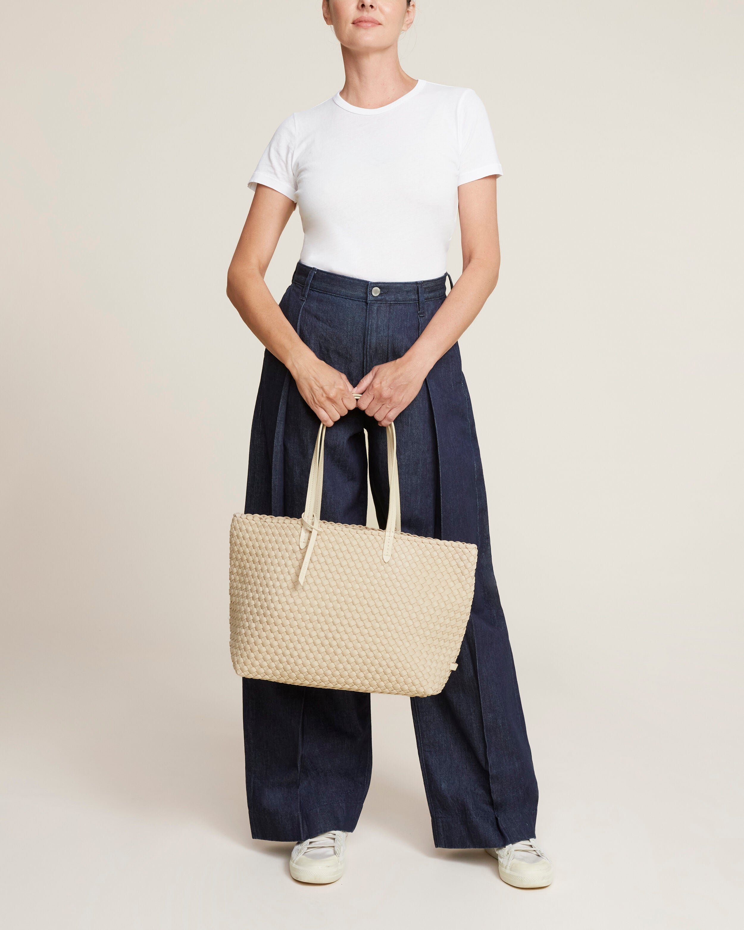 Jetsetter Tote in Ecru shown on model to illustrate scale and soft silhouette.