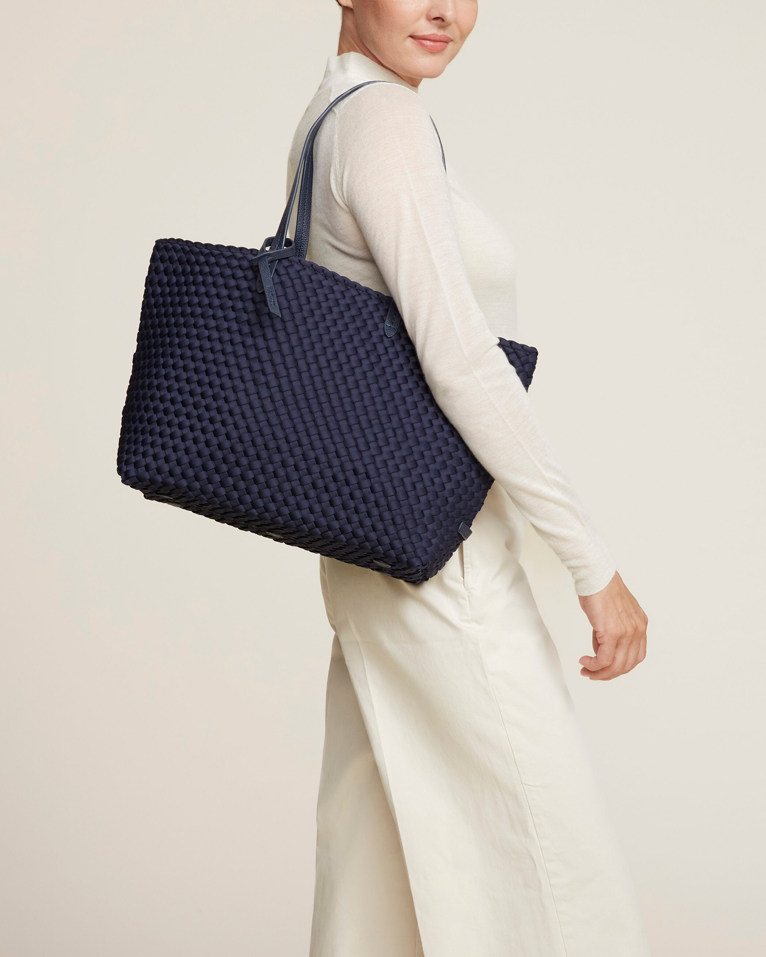 Jetsetter Tote in Ink Blue shown on model to illustrate scale and soft silhouette.