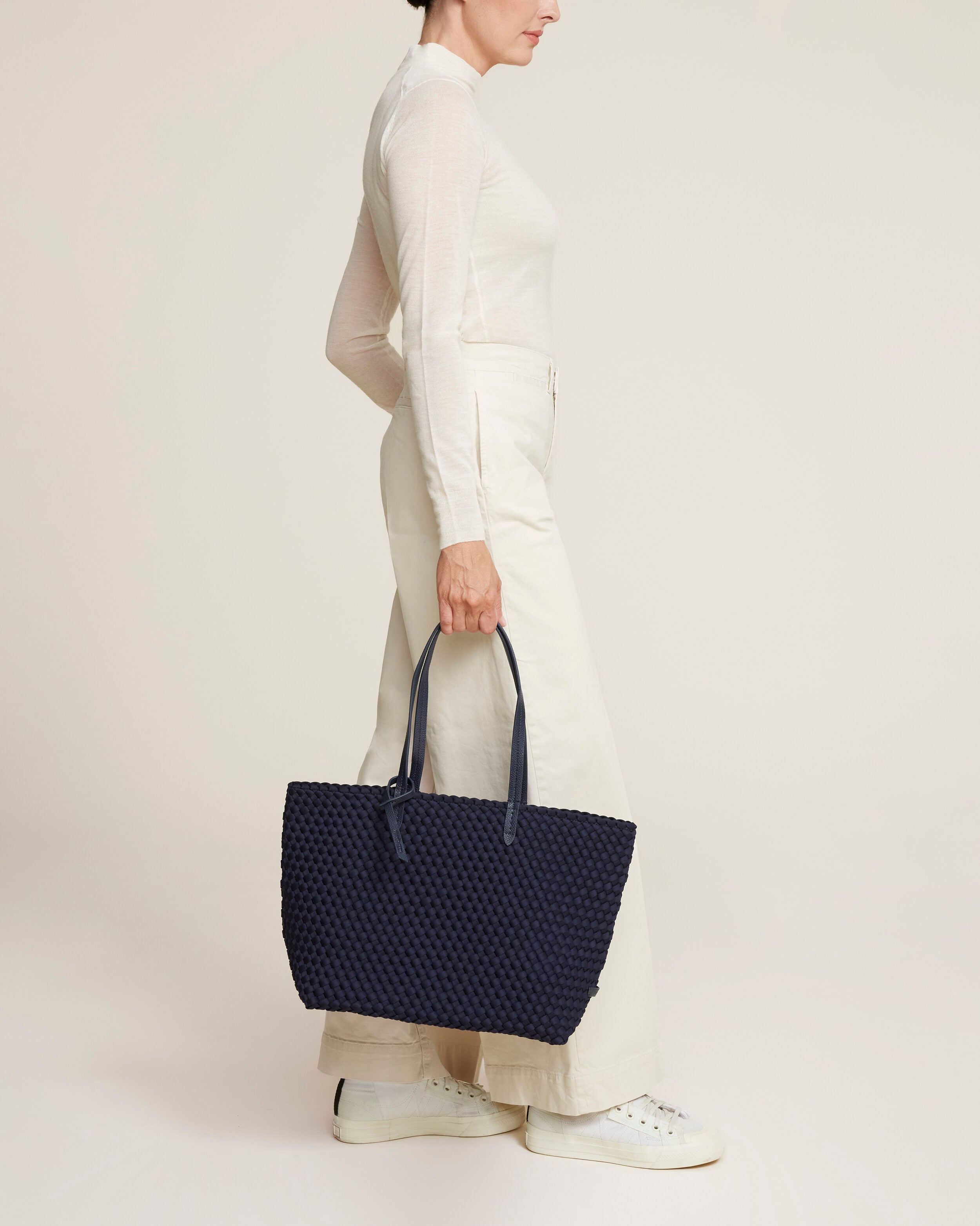 Jetsetter Tote in Ink Blue shown on model to illustrate scale and soft silhouette.