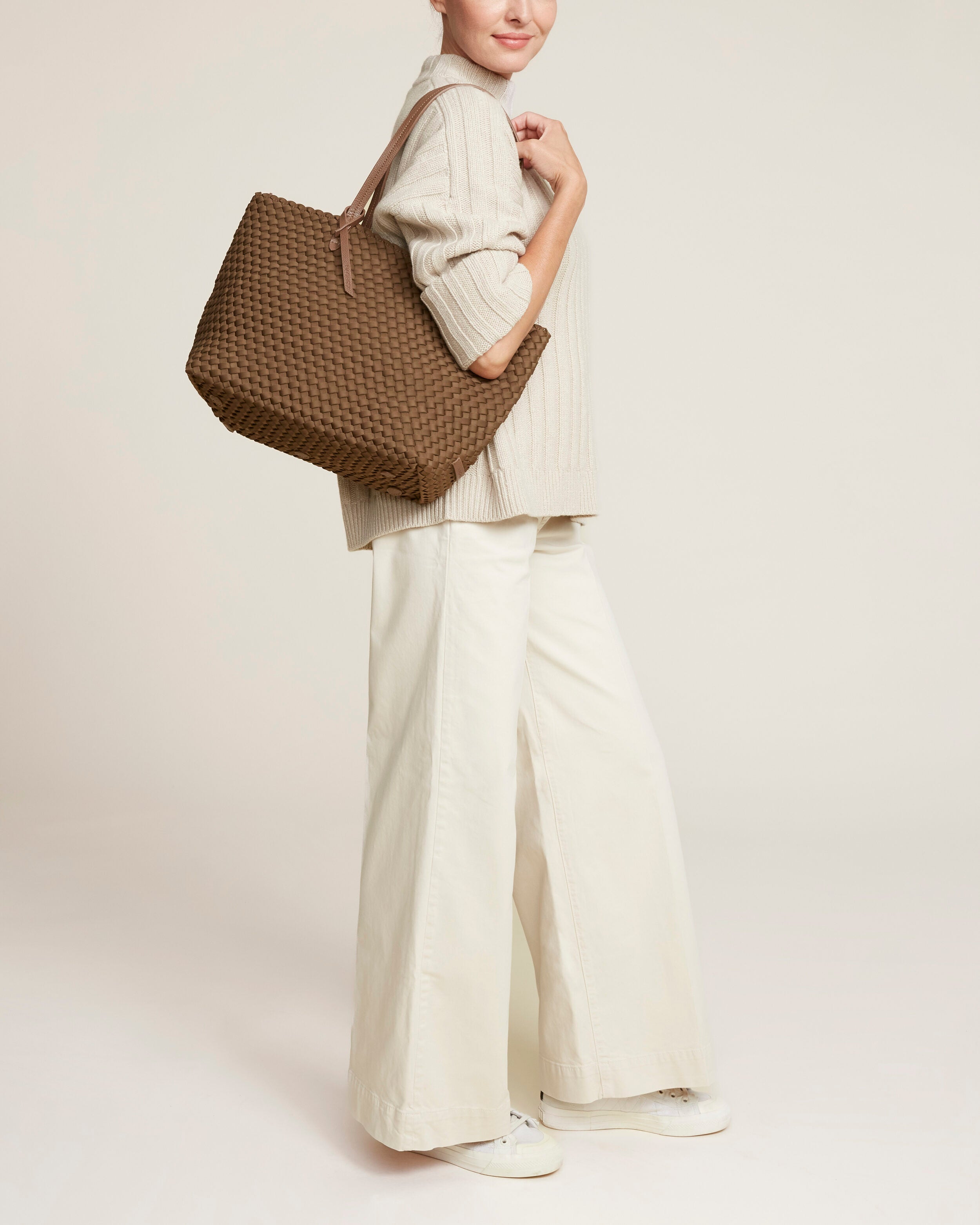 Jetsetter Tote in Mink shown on model to illustrate scale and soft silhouette.