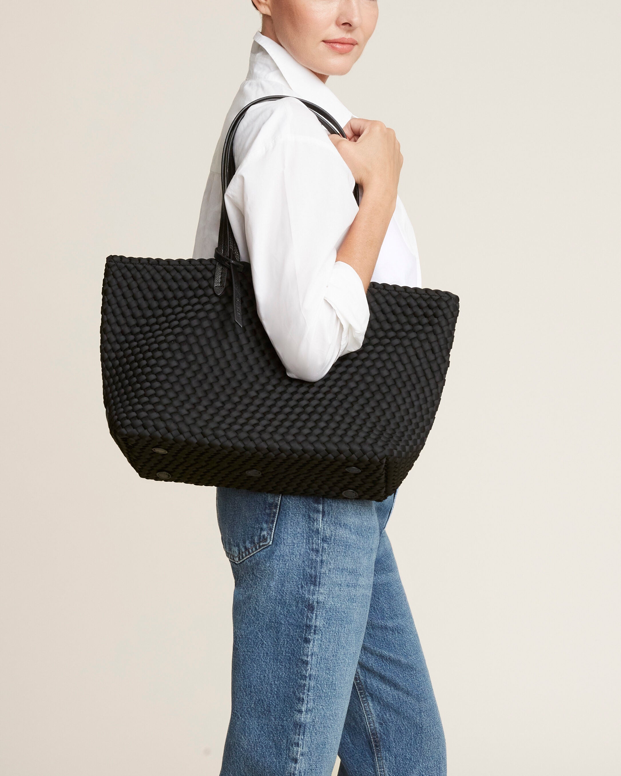 Jetsetter Tote in Onyx shown on model to illustrate scale and soft silhouette.
