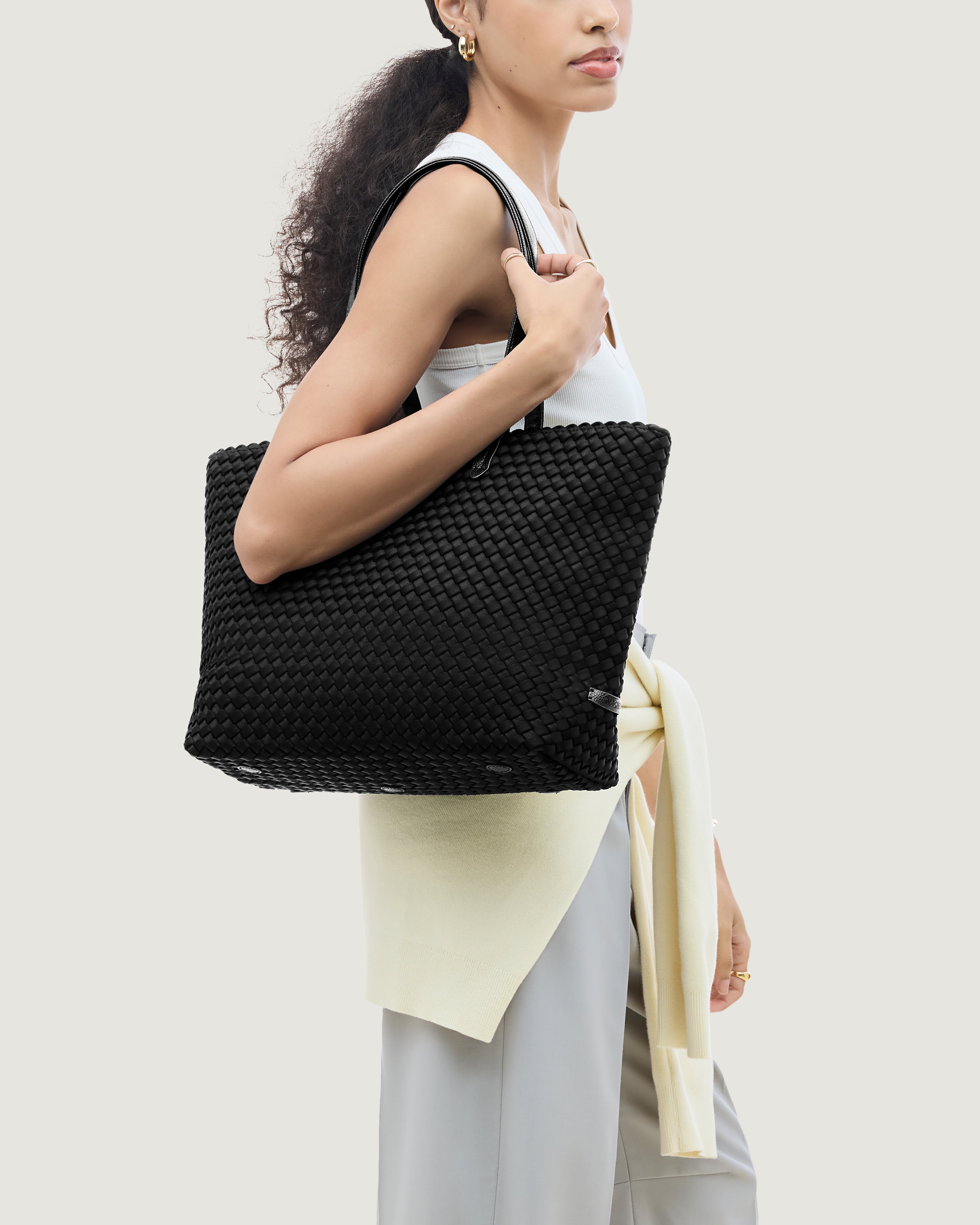 Jetsetter Tote in Onyx shown on model to illustrate scale and soft silhouette.