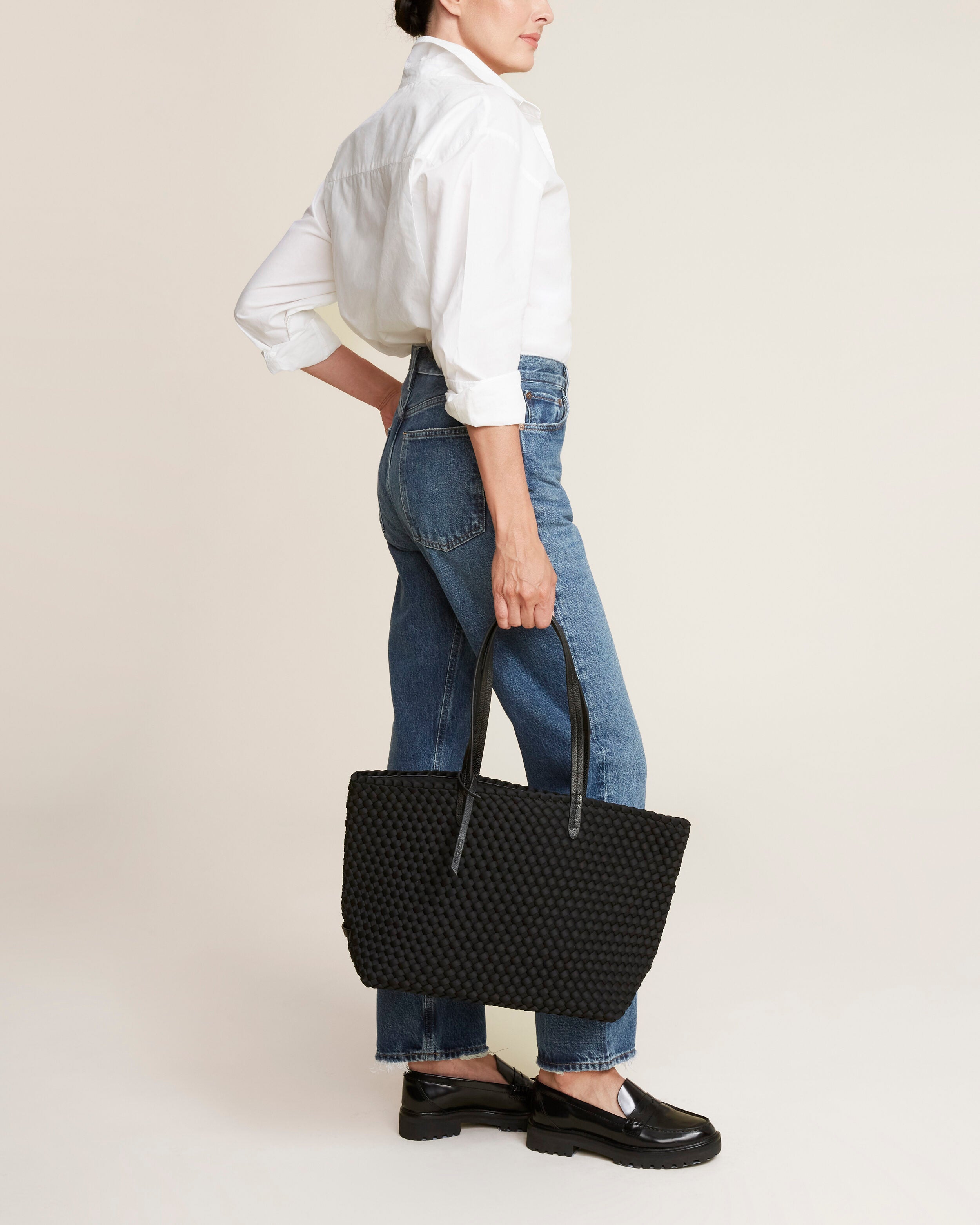 Jetsetter Tote in Onyx shown on model to illustrate scale and soft silhouette.