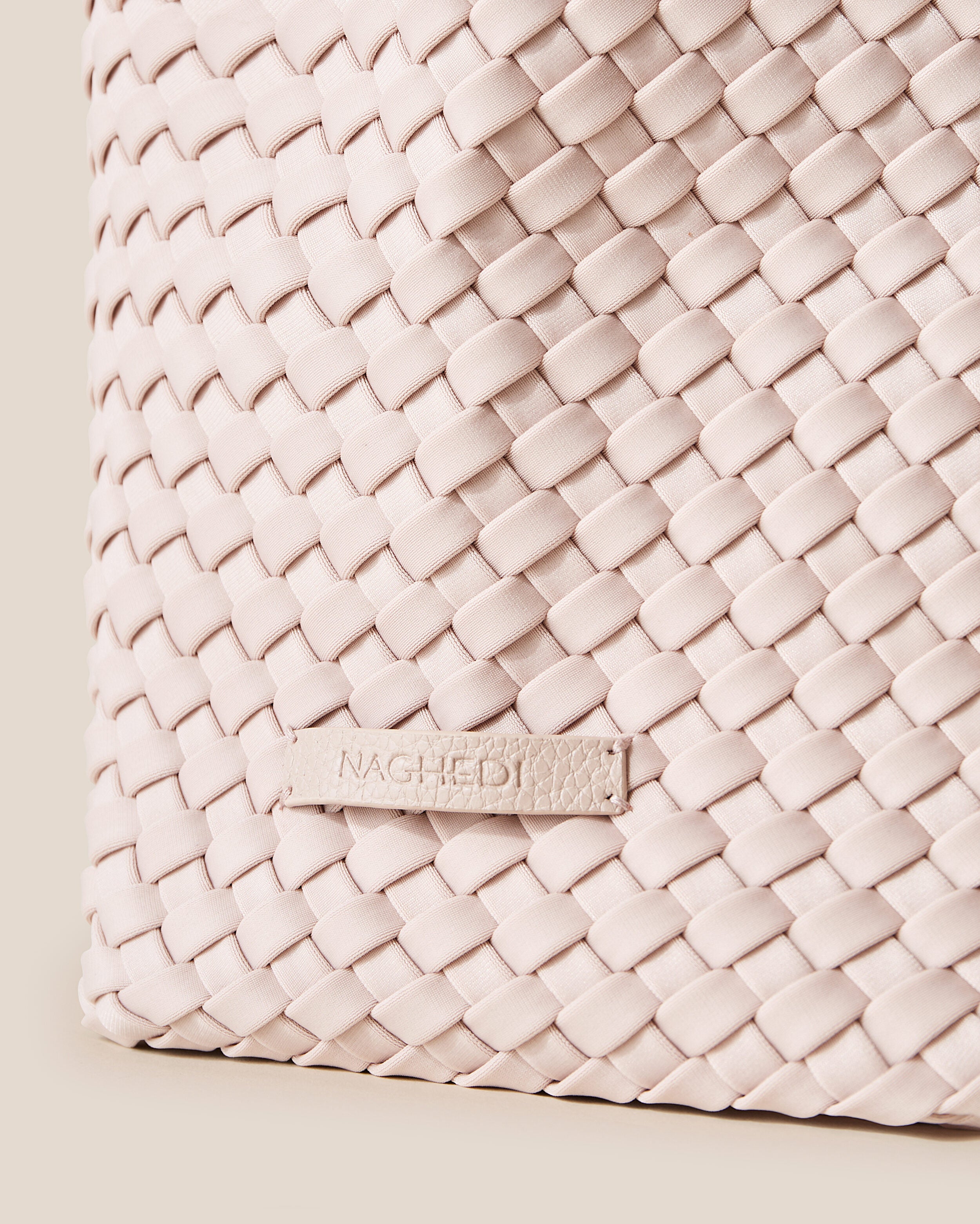 Close-up of stamped NAGHEDI logo on Jetsetter Tote in Shell Pink.