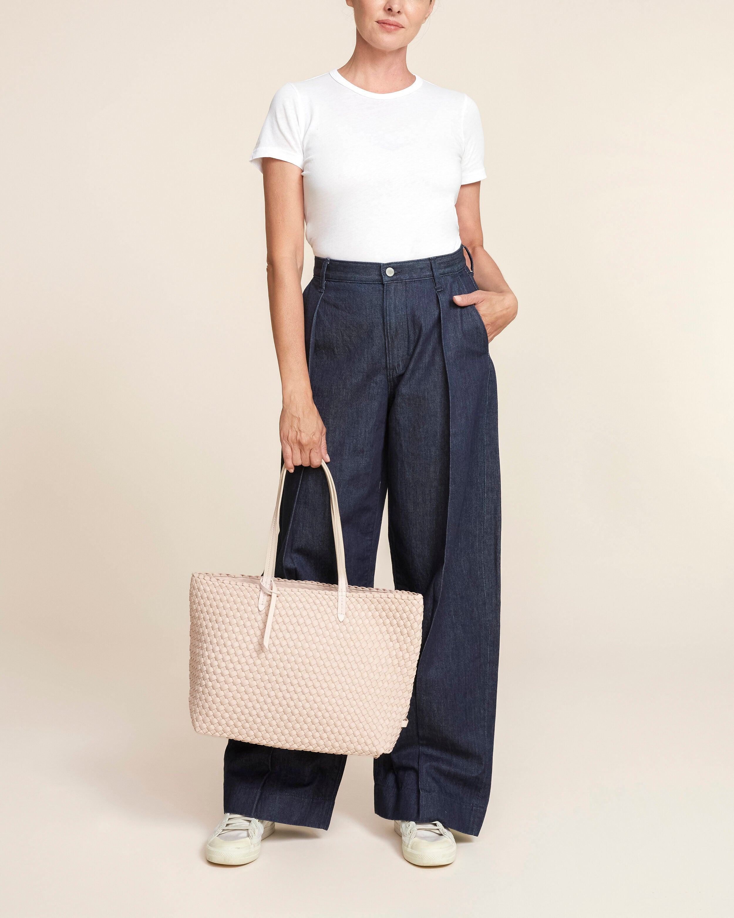 Jetsetter Tote in Shell Pink shown on model to illustrate scale and soft silhouette.