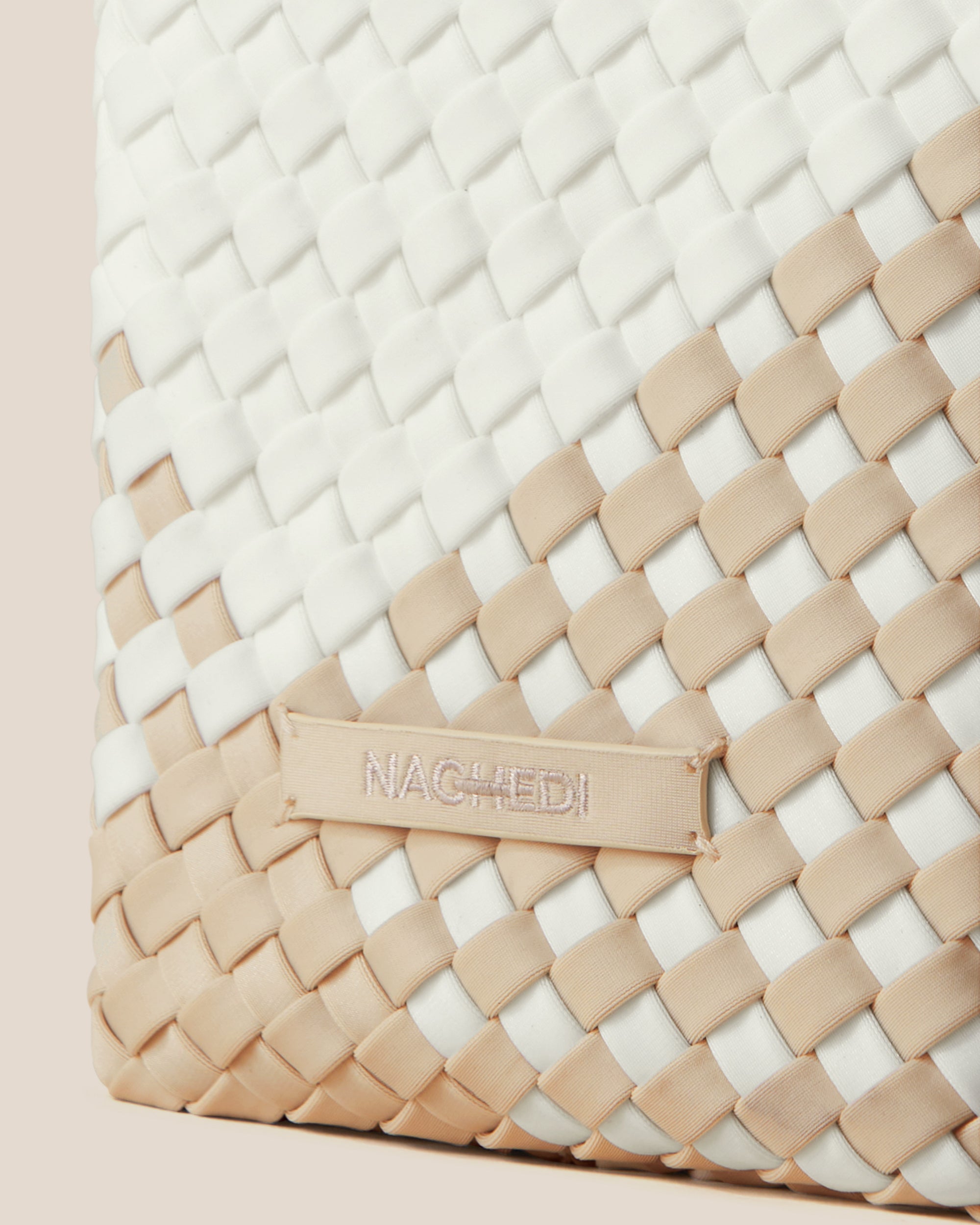 Close-up of stamped NAGHEDI logo on Kyoto Clutch in Athena.