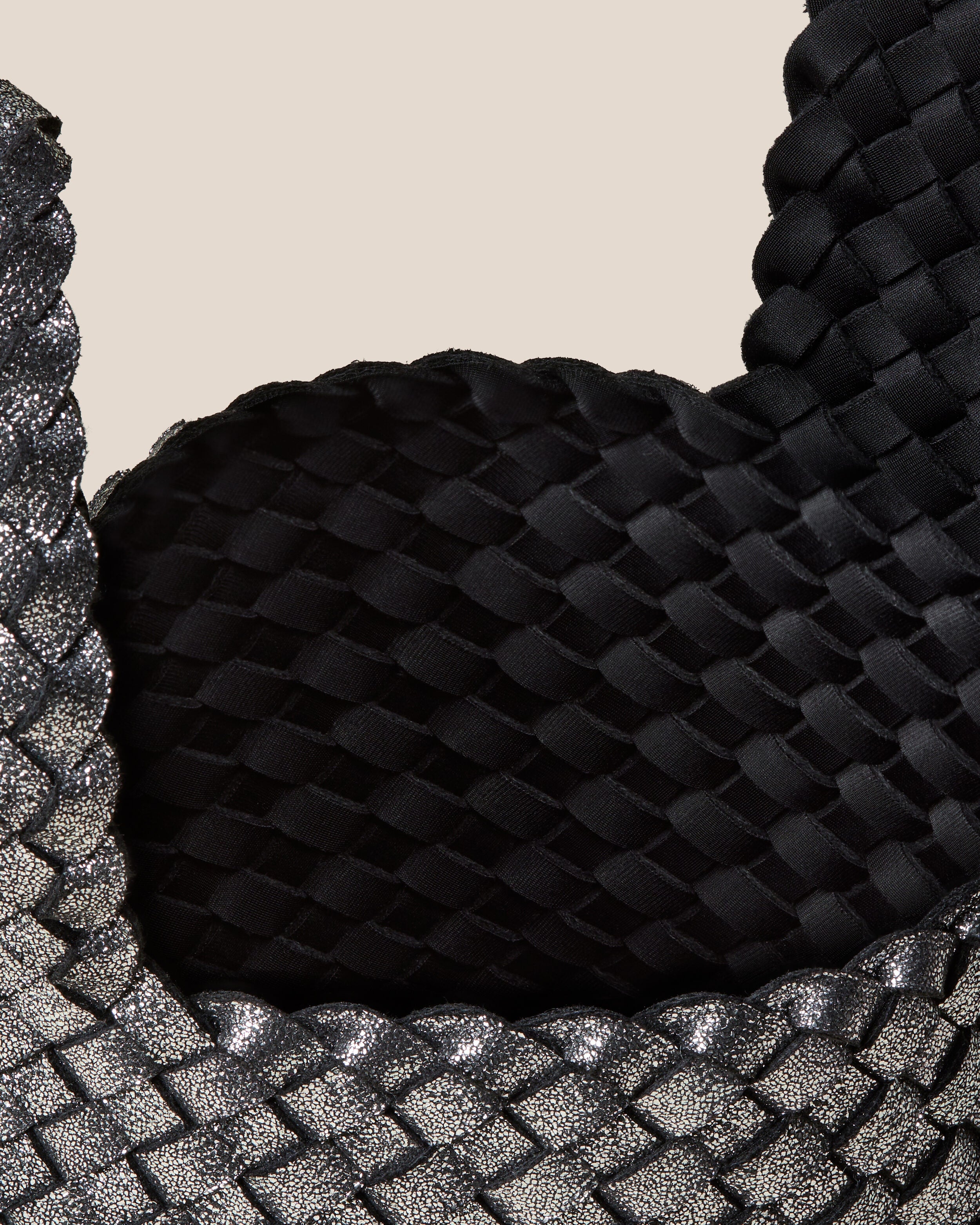 Interior close-up of Kyoto Clutch in Titanium showing its secure slide-through loop closure, and unlined interior.