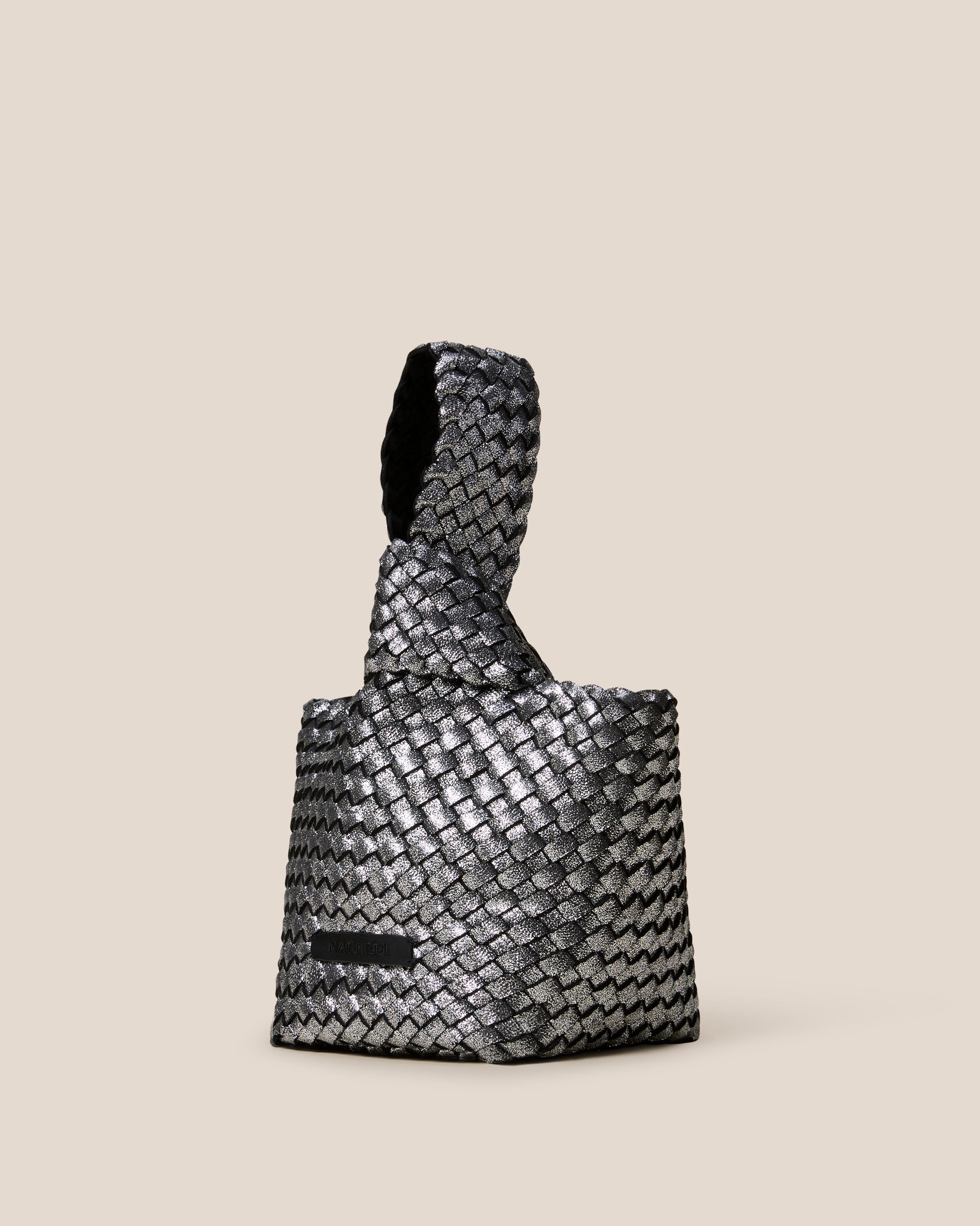 Kyoto Clutch in Titanium shown from a side angle, highlighting its handwoven neoprene construction and secure slide-through loop closure.