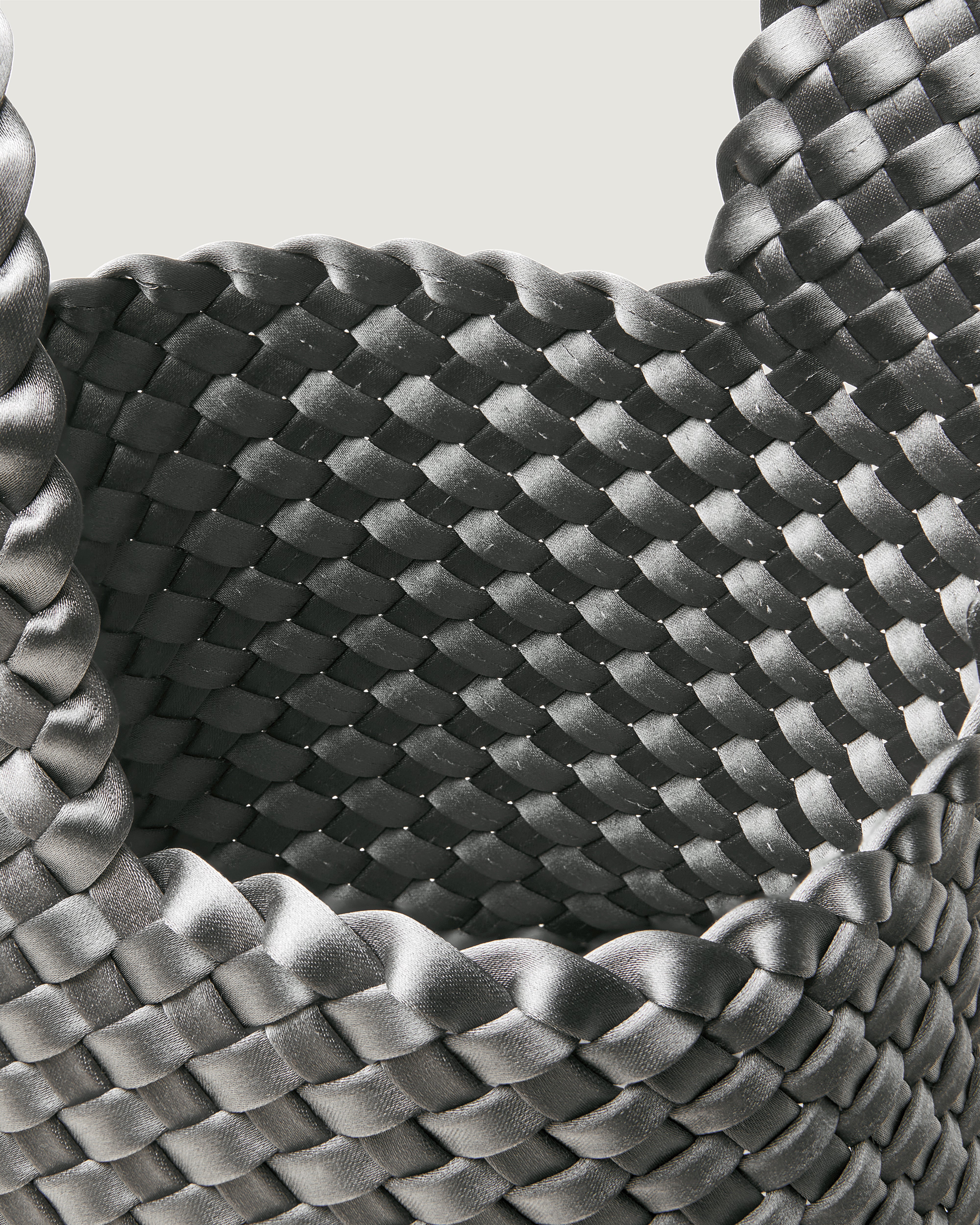 Interior close-up of Kyoto Clutch in Graphite showing its secure slide-through loop closure, and unlined interior.