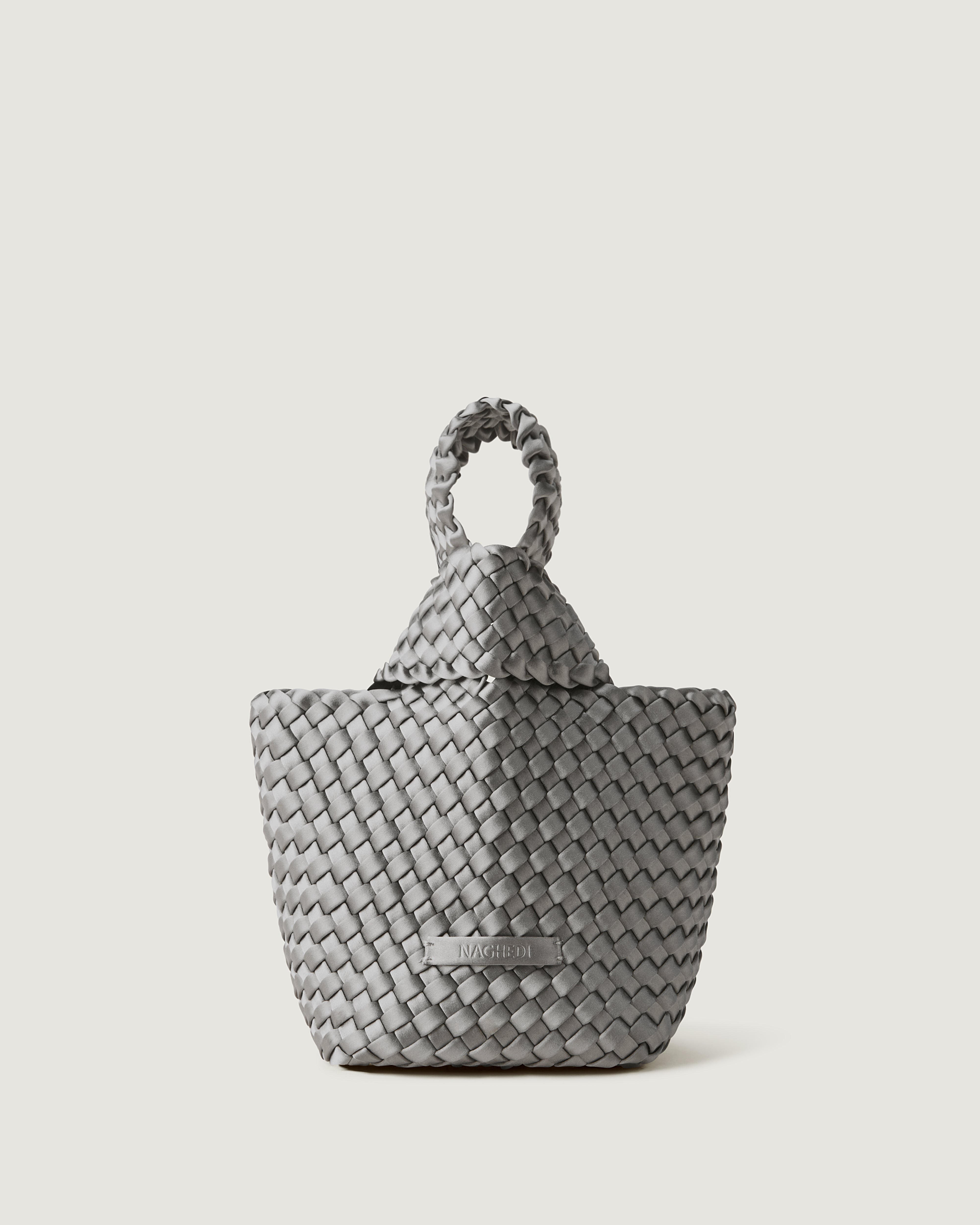 Kyoto Clutch in Graphite, a dark blue grey tone, in handwoven satin, featuring a secure slide-through loop closure.