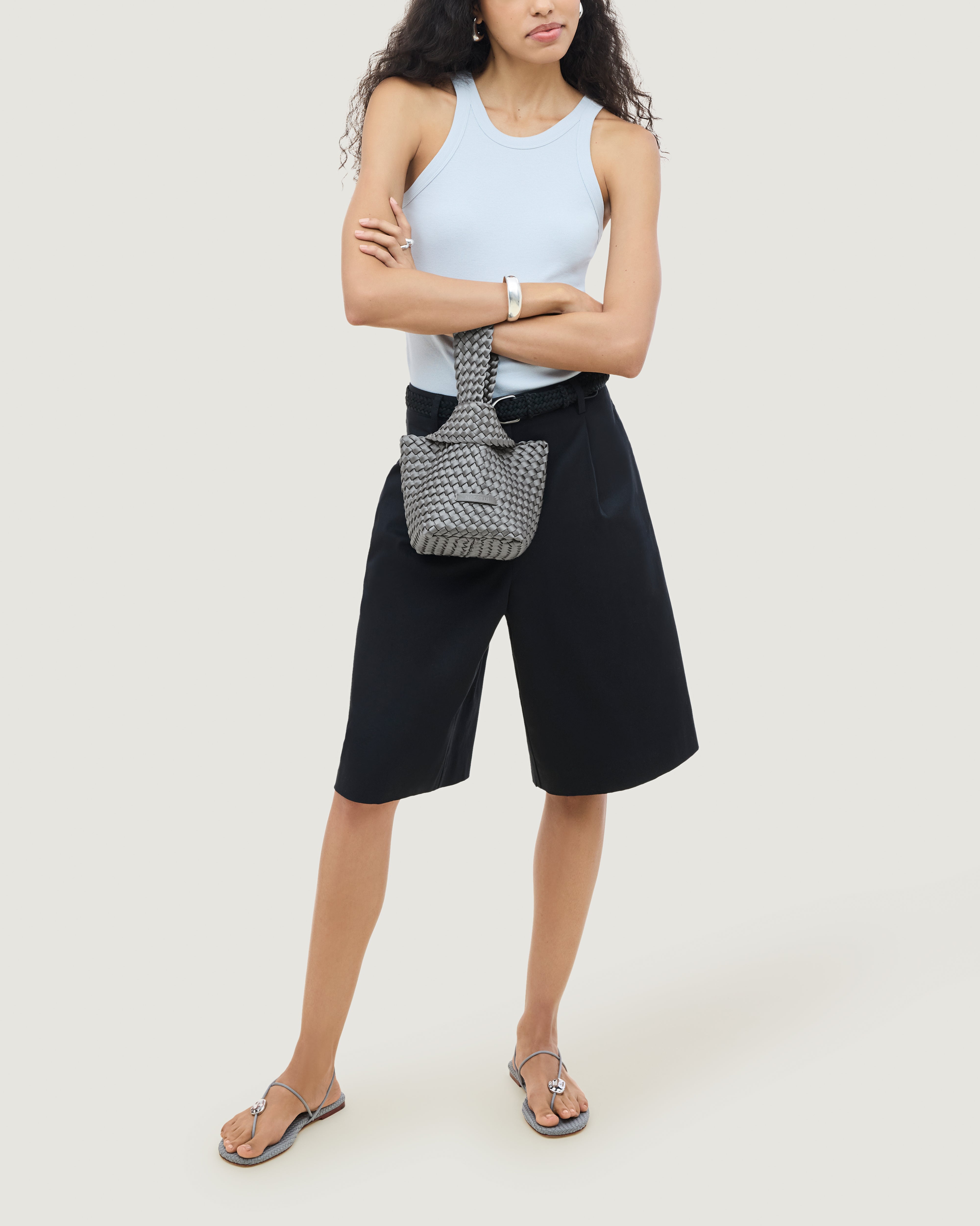 Kyoto Clutch in Graphite shown on model to illustrate scale and soft silhouette.