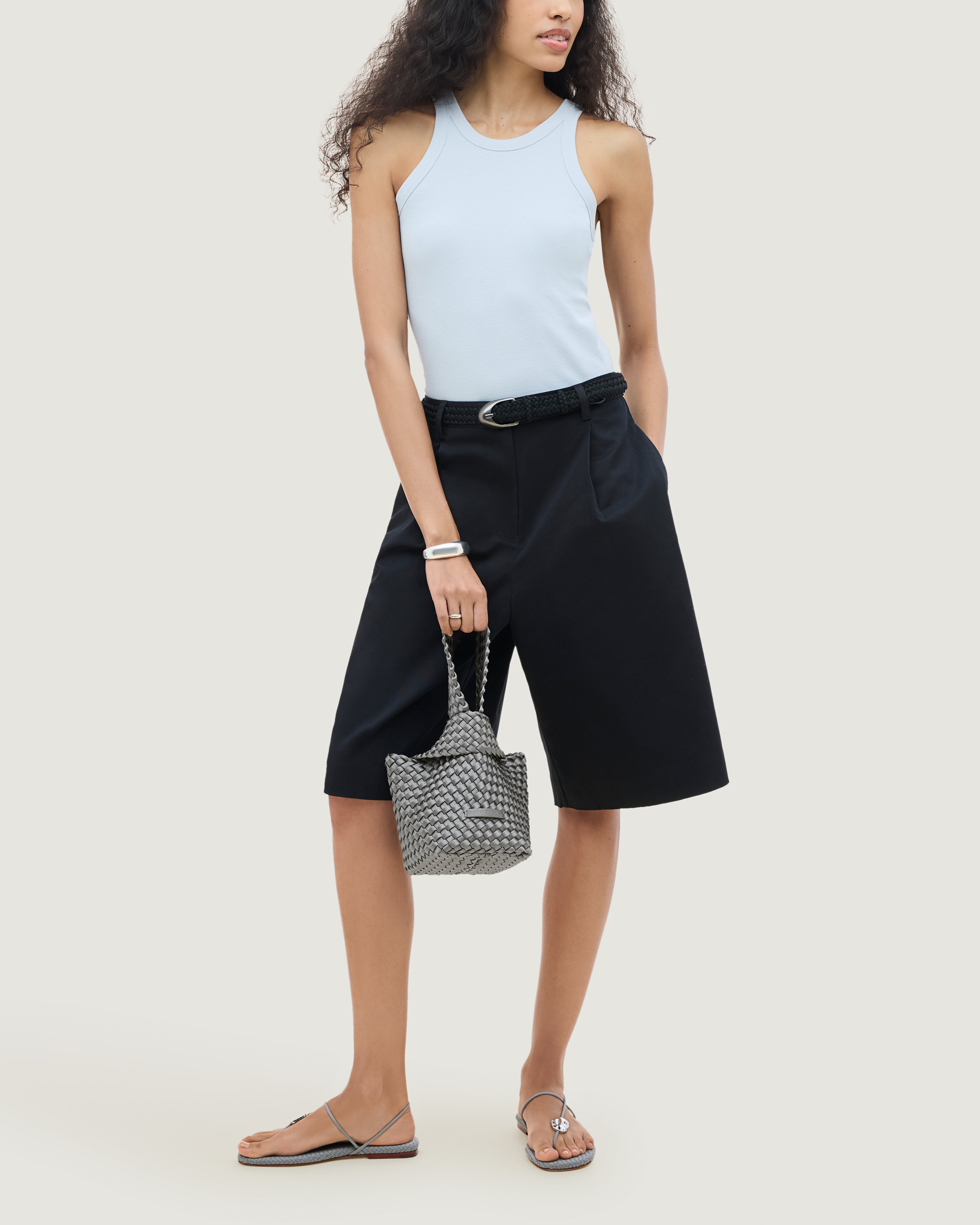 Kyoto Clutch in Graphite shown on model to illustrate scale and soft silhouette.