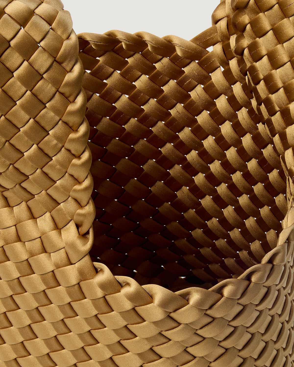 Interior close-up of Kyoto Clutch in Luce showing its secure slide-through loop closure, and unlined interior.
