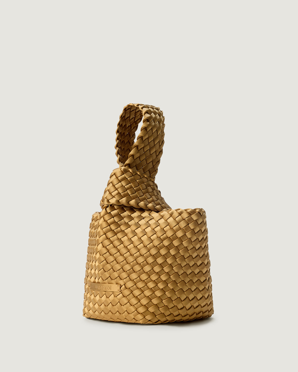 Kyoto Clutch in Luce shown from a side angle, highlighting its handwoven satin construction and secure slide-through loop closure.