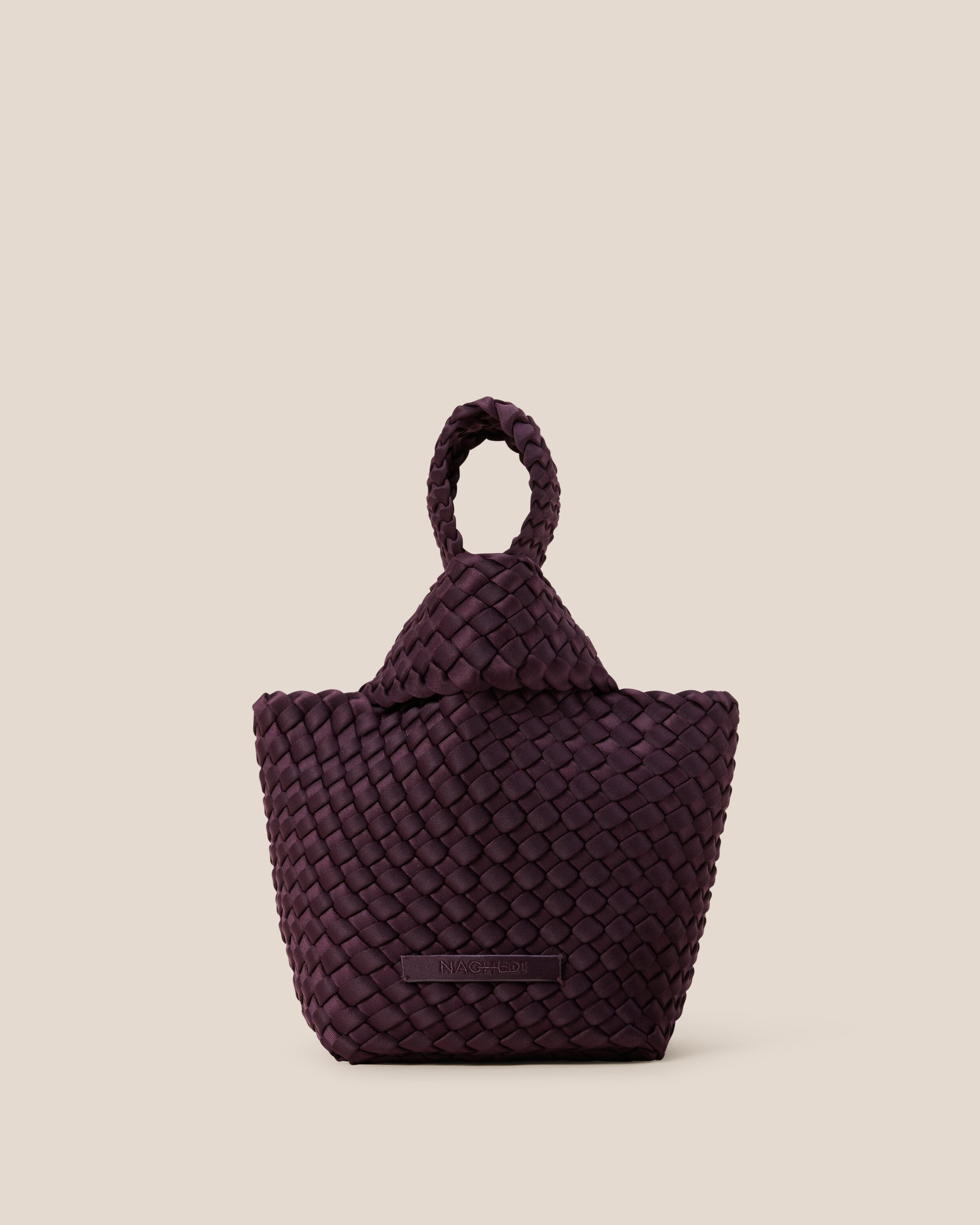 Kyoto Clutch in Aubergine, a dark purple tone, in handwoven neoprene, featuring a secure slide-through loop closure.