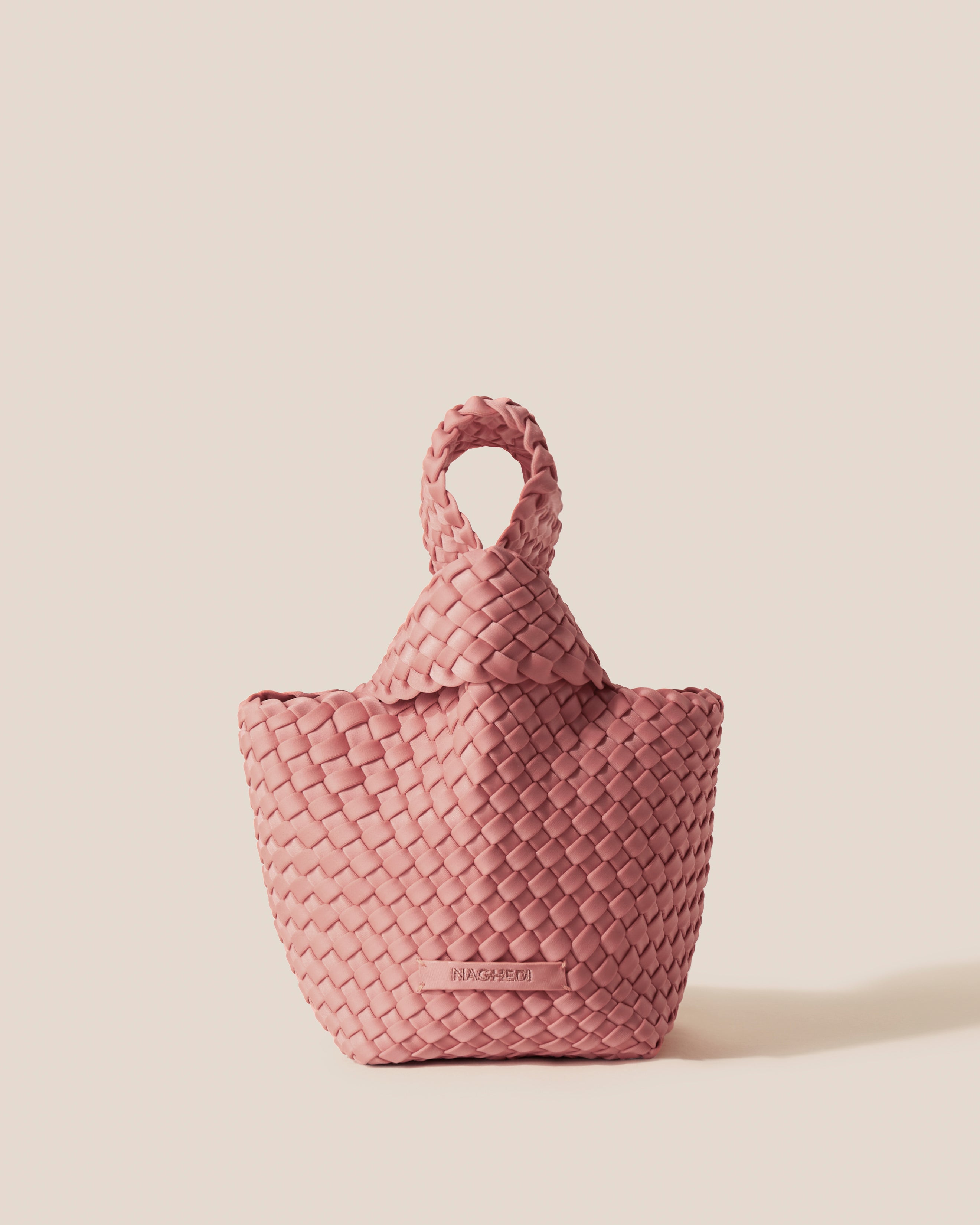 Kyoto Clutch in Dusk, a dusty rose pink tone, in handwoven neoprene, featuring a secure slide-through loop closure.