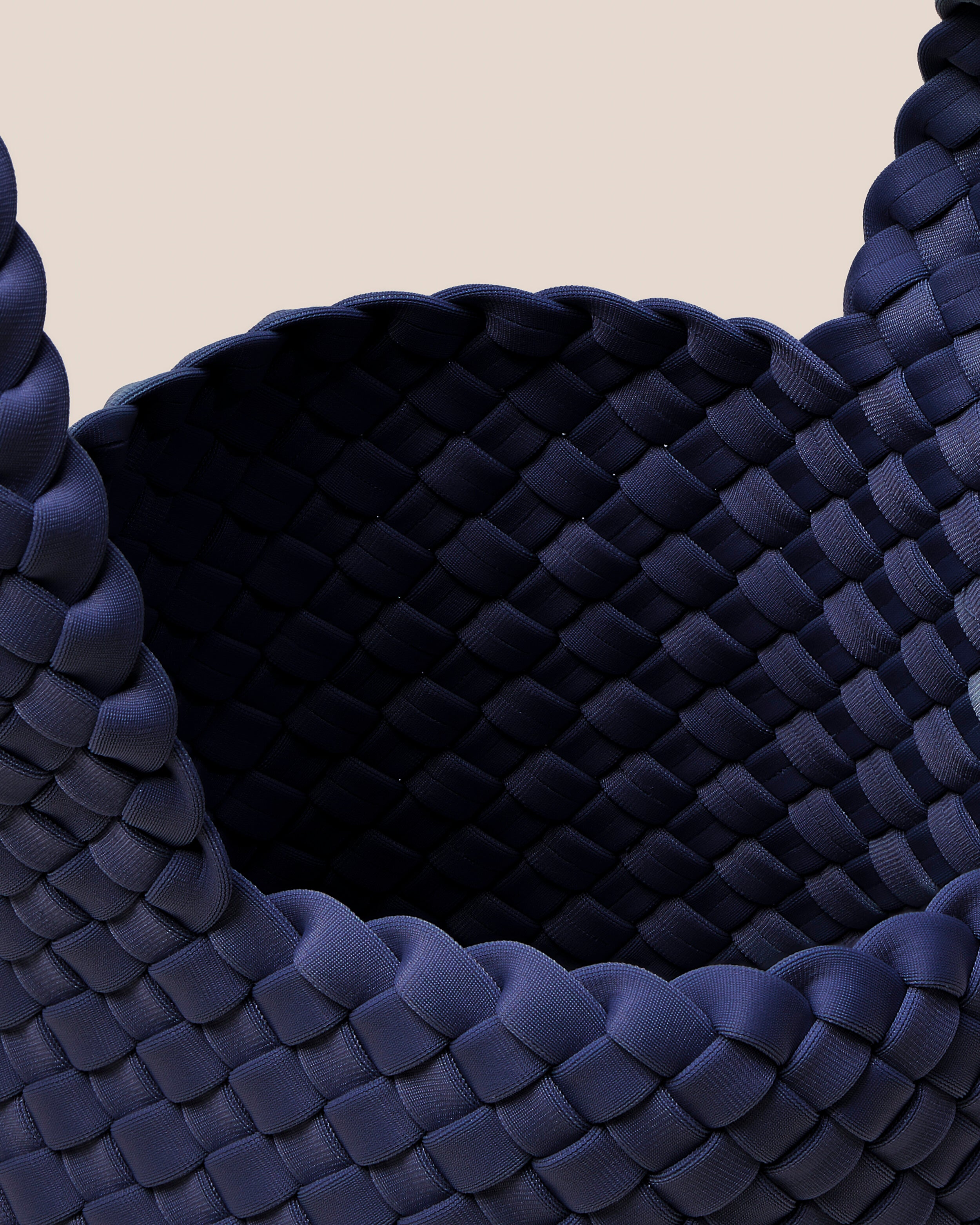 Interior close-up of Kyoto Clutch in Ink Blue showing its secure slide-through loop closure, and unlined interior.