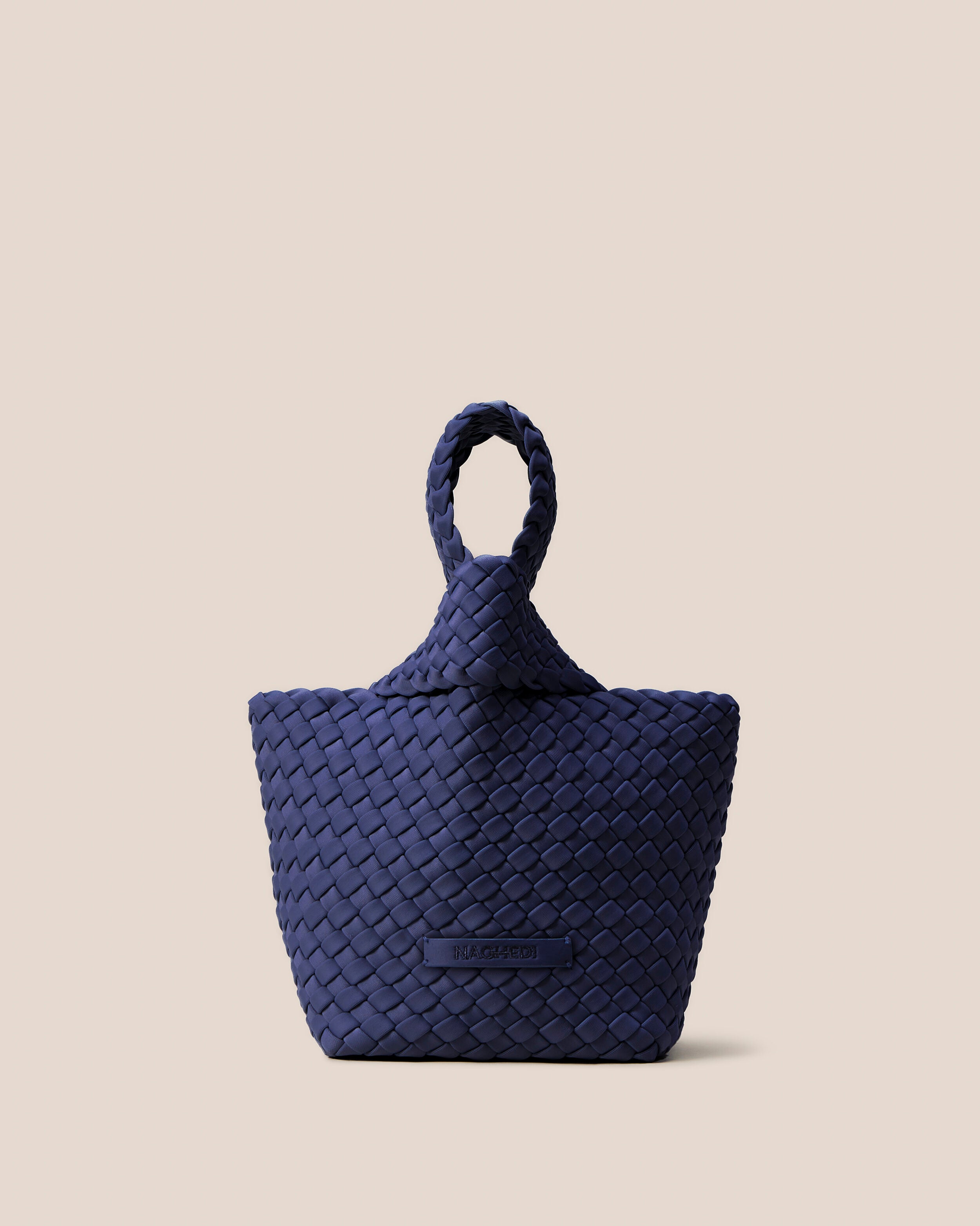 Kyoto Clutch in Ink Blue, a navy blue tone, in handwoven neoprene, featuring a secure slide-through loop closure.