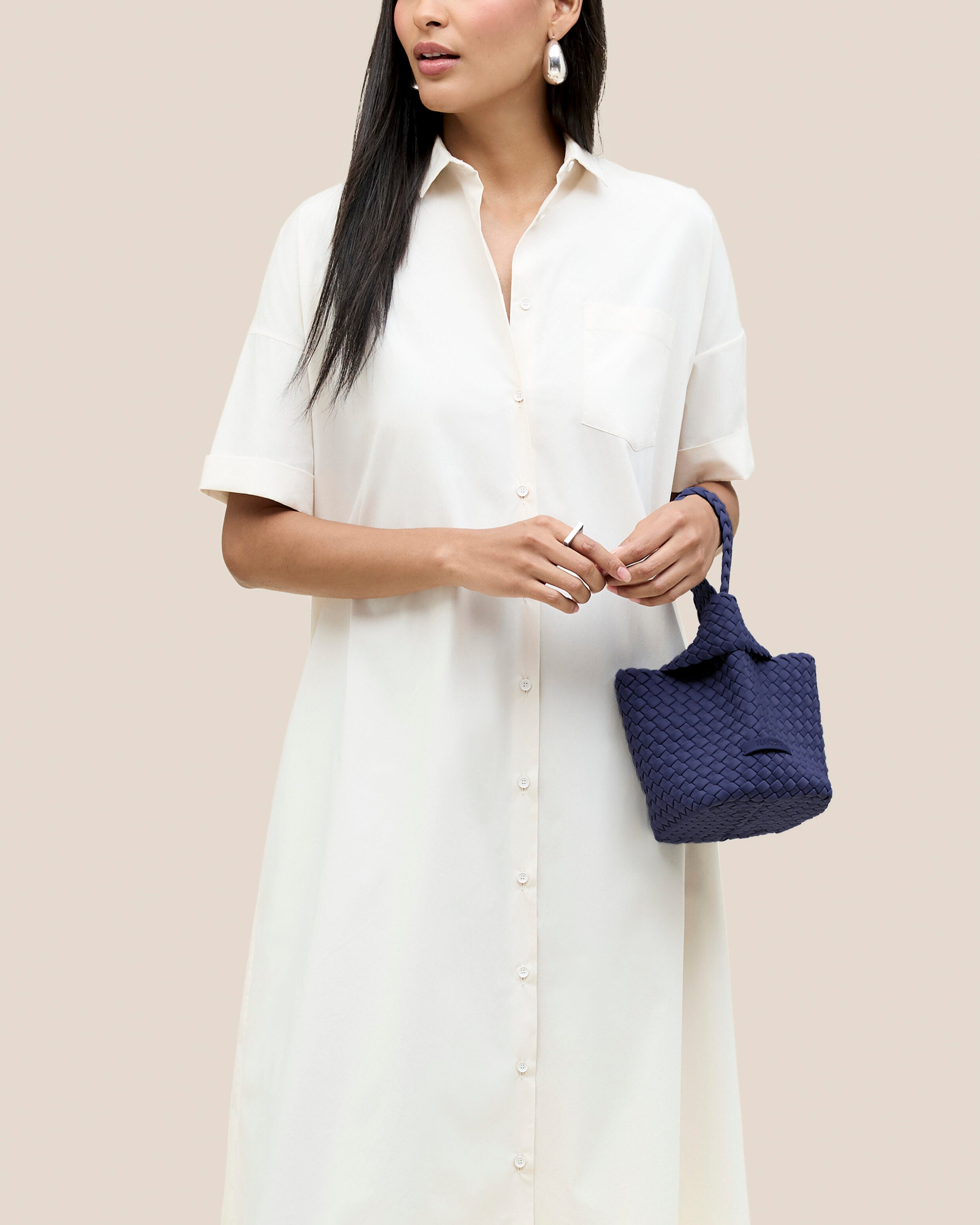 Kyoto Clutch in Ink Blue shown on model to illustrate scale and soft silhouette.