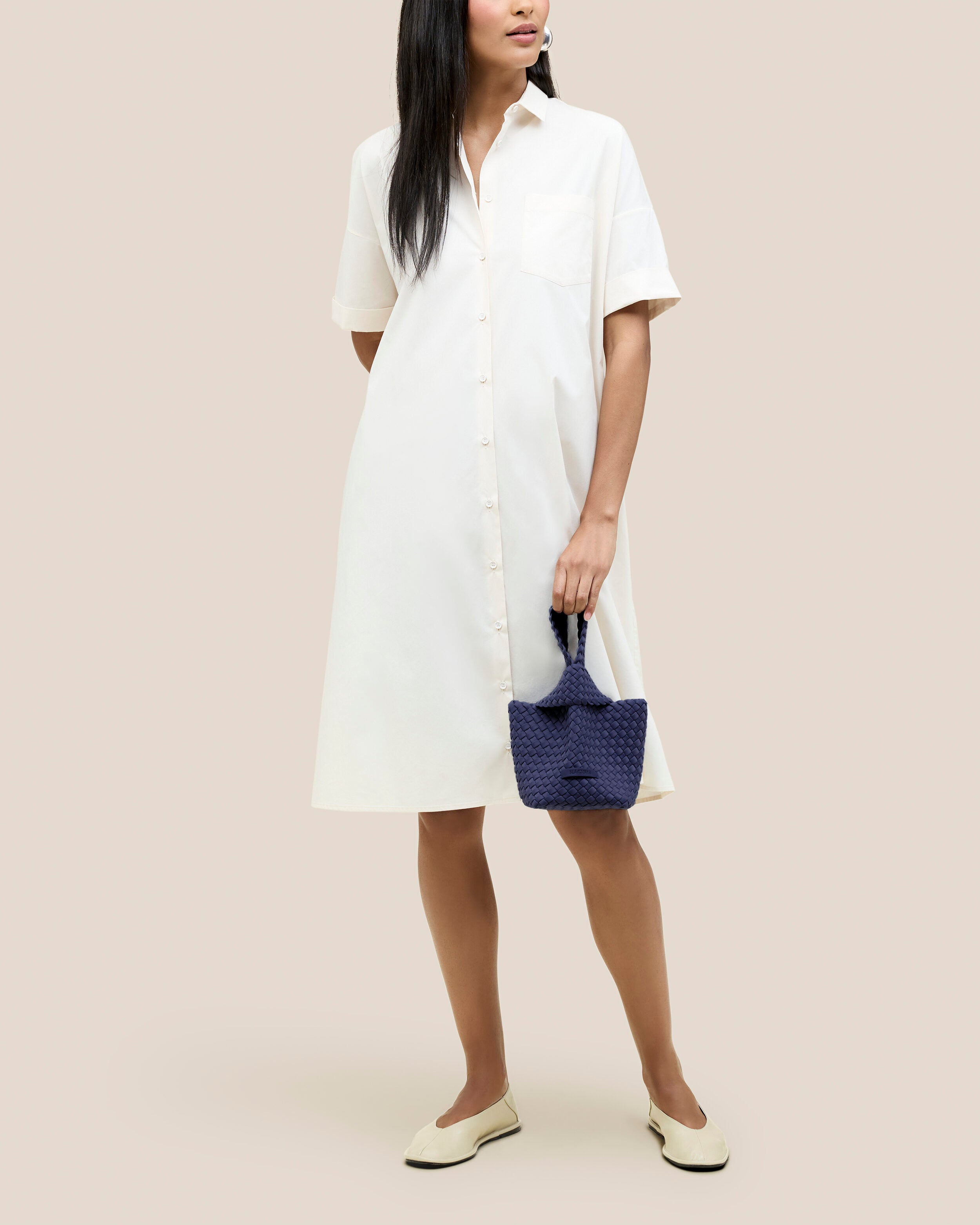 Kyoto Clutch in Ink Blue shown on model to illustrate scale and soft silhouette.