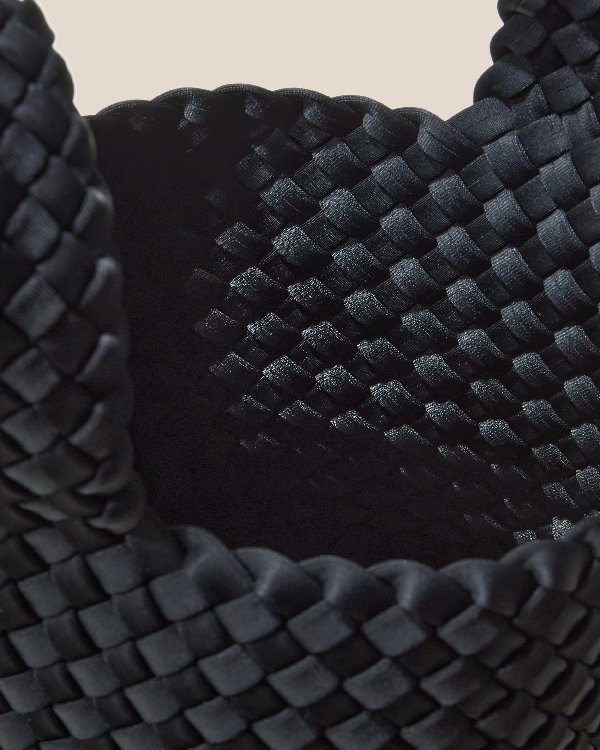 Interior close-up of Kyoto Clutch in Onyx showing its secure slide-through loop closure, and unlined interior.