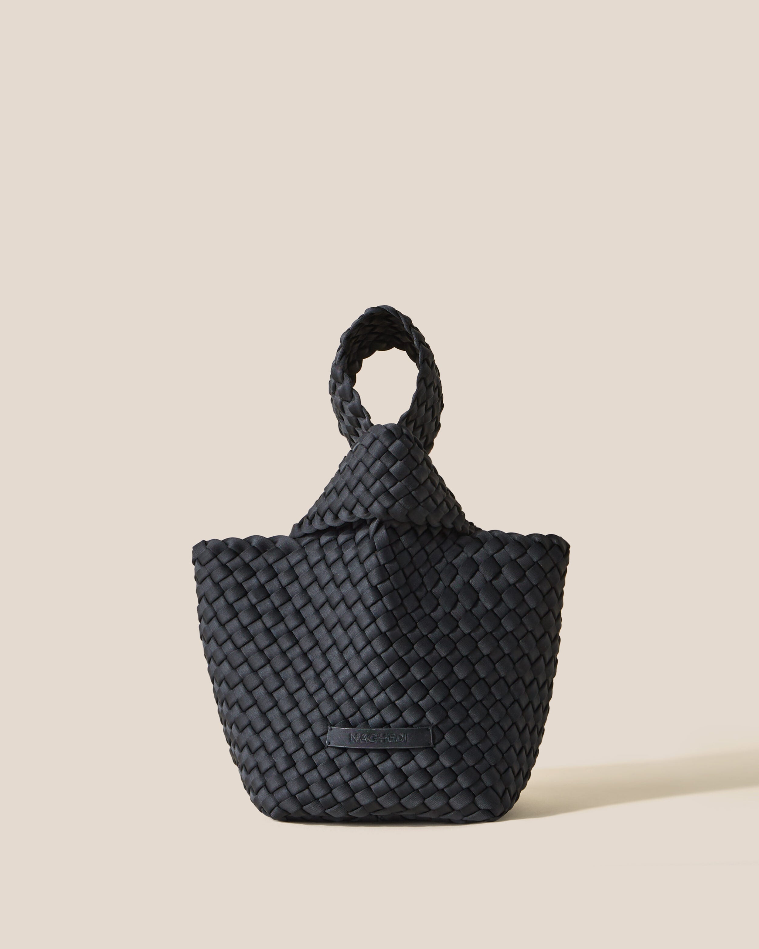 Kyoto Clutch in Onyx, a true black tone, in handwoven neoprene, featuring a secure slide-through loop closure.