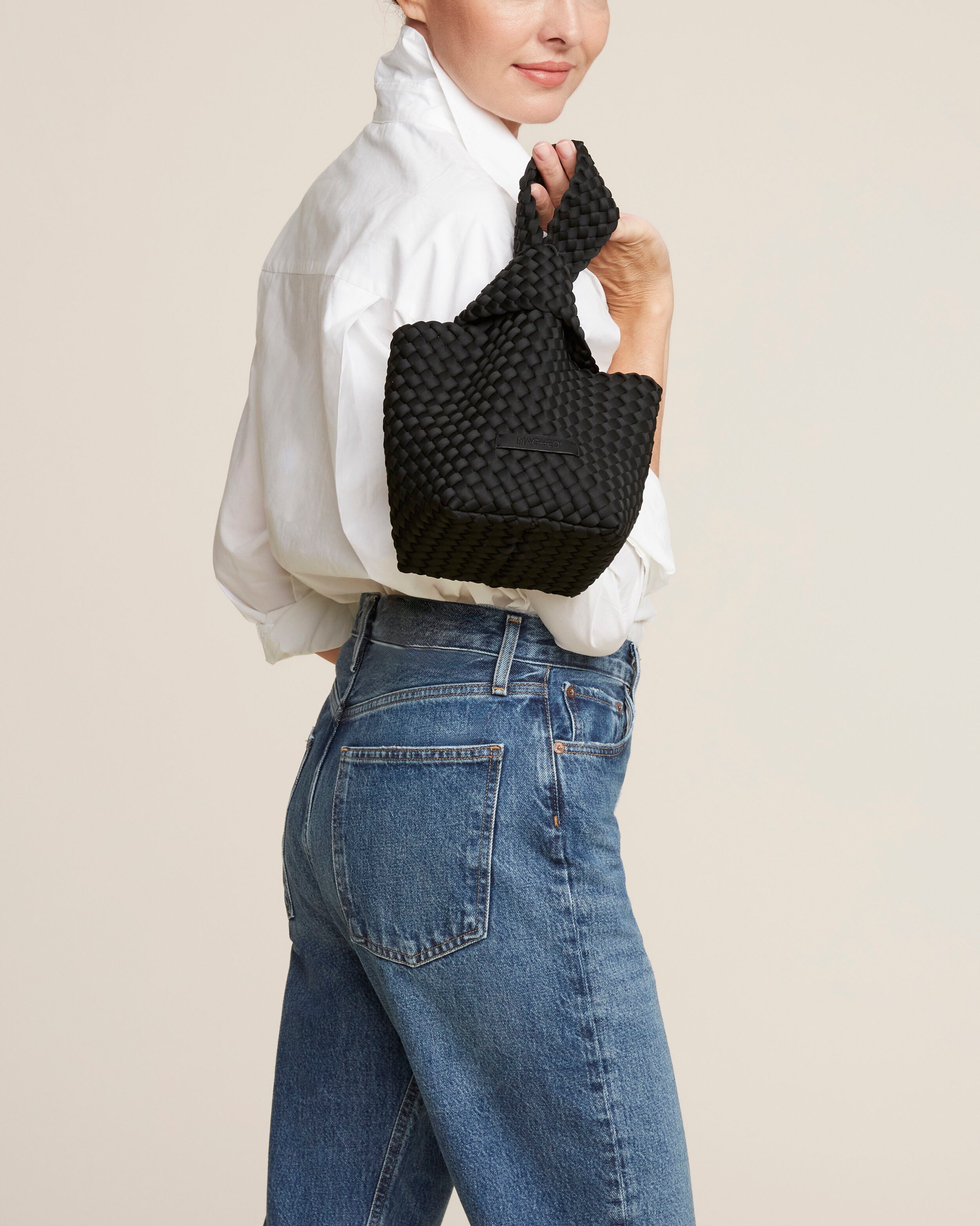 Kyoto Clutch in Onyx shown on model to illustrate scale and soft silhouette.