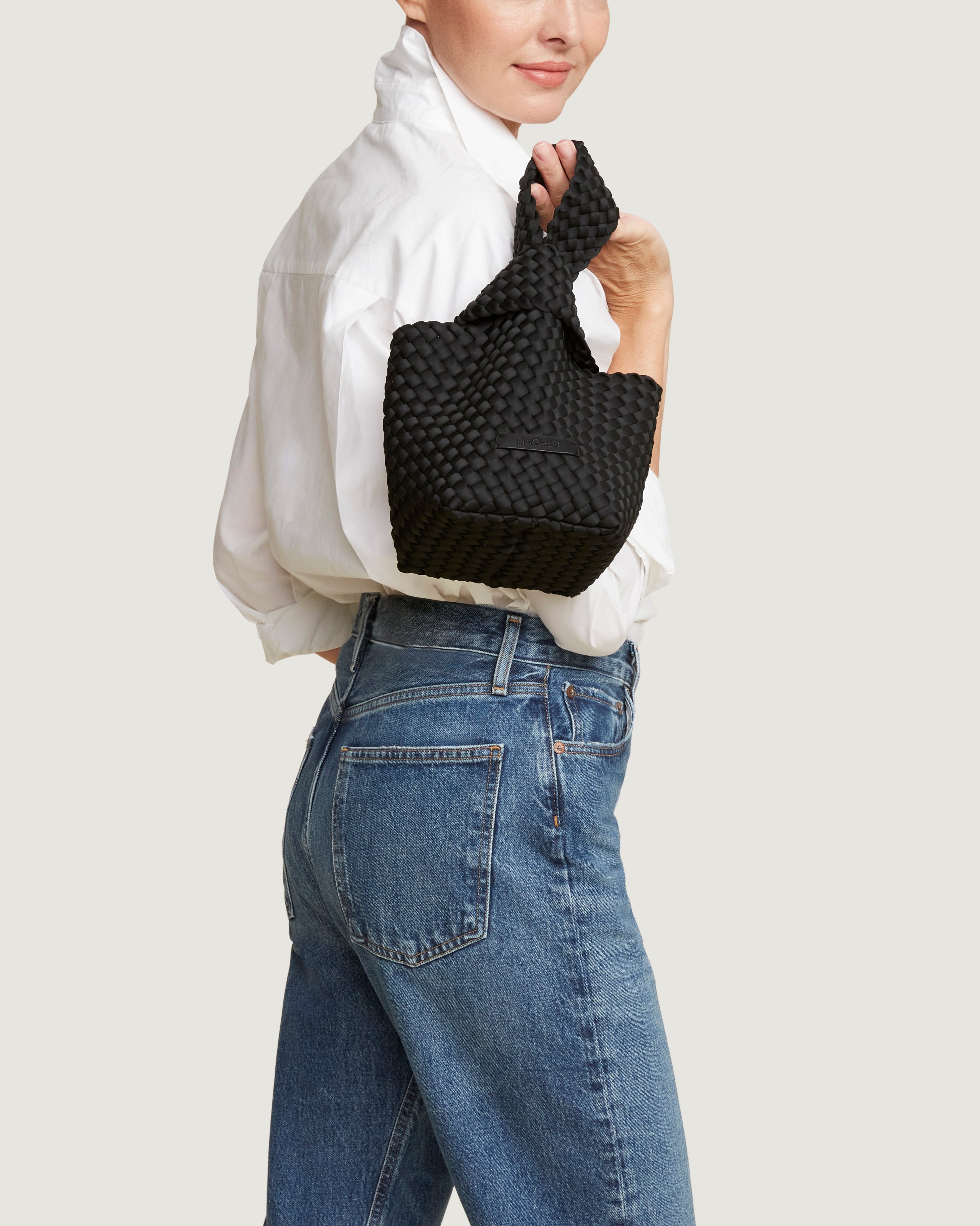 Kyoto Clutch in Onyx shown on model to illustrate scale and soft silhouette.