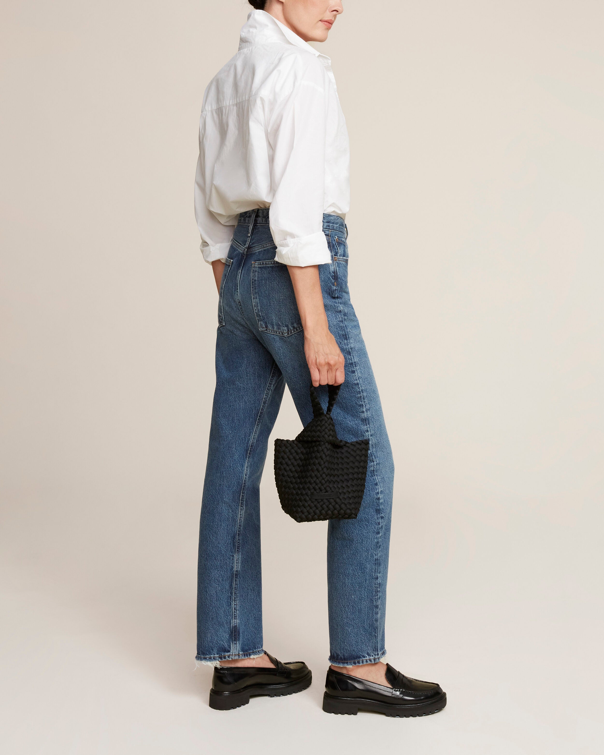 Kyoto Clutch in Onyx shown on model to illustrate scale and soft silhouette.