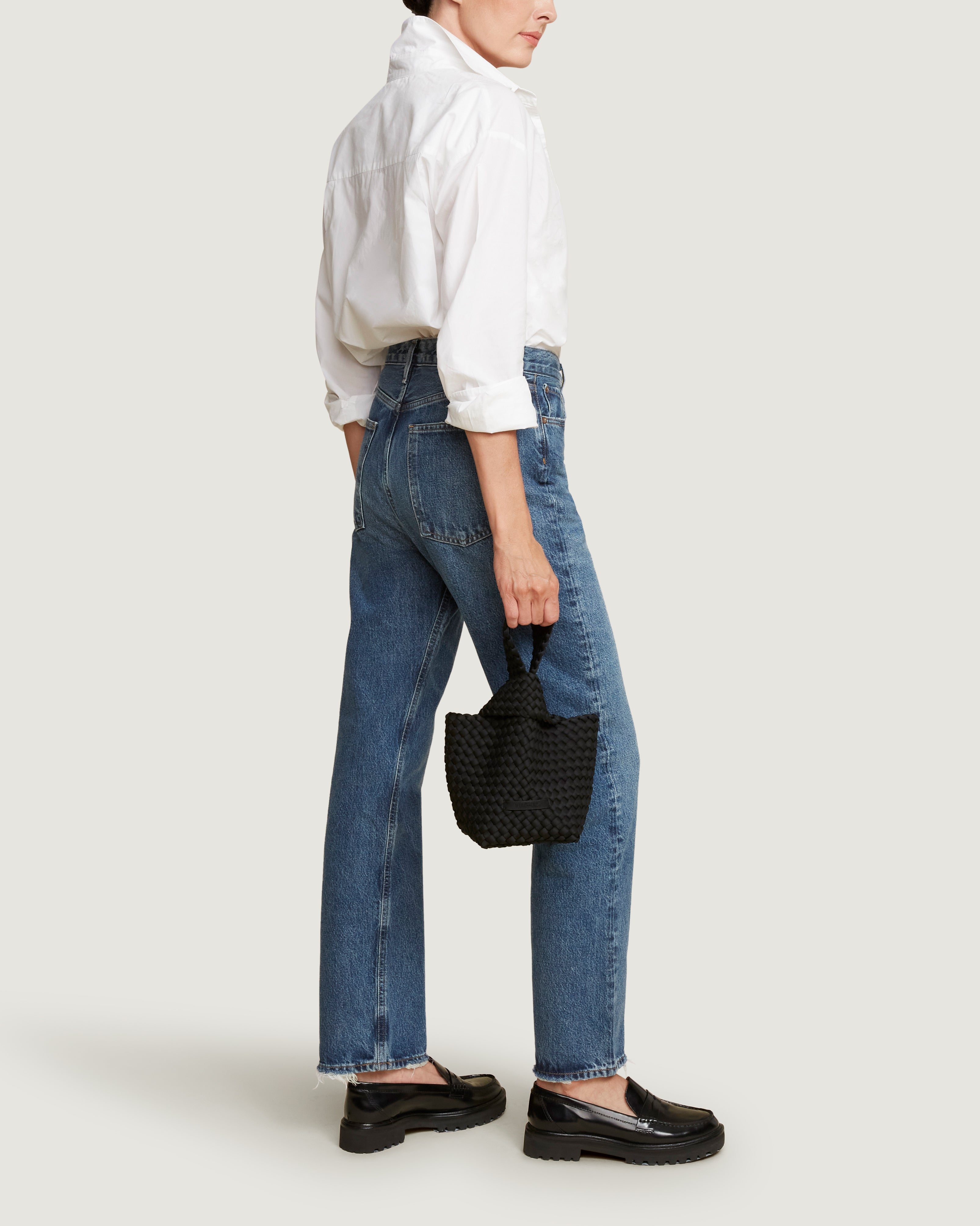 Kyoto Clutch in Onyx shown on model to illustrate scale and soft silhouette.