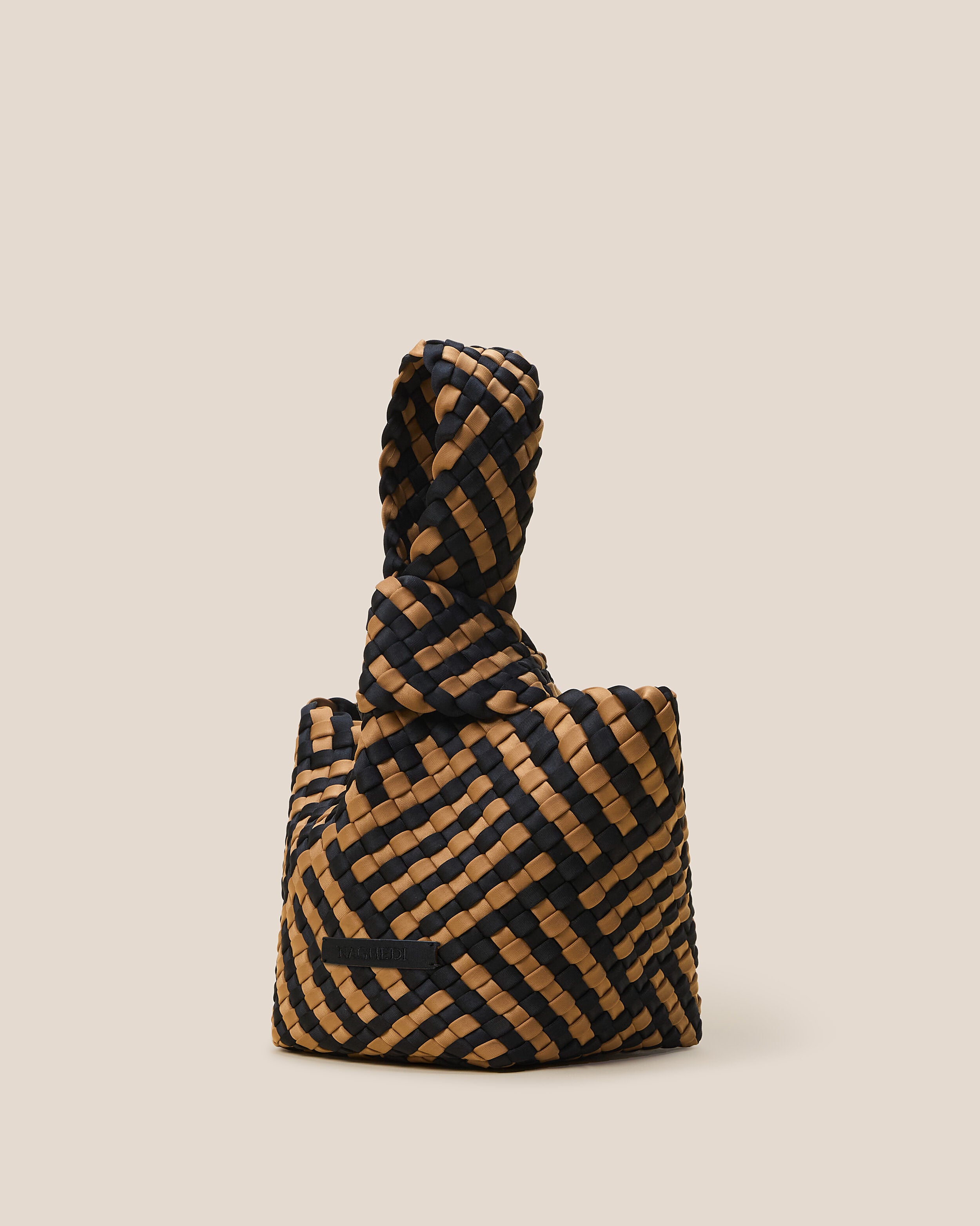 Kyoto Clutch in Ravenna shown from a side angle, highlighting its handwoven neoprene construction and secure slide-through loop closure.