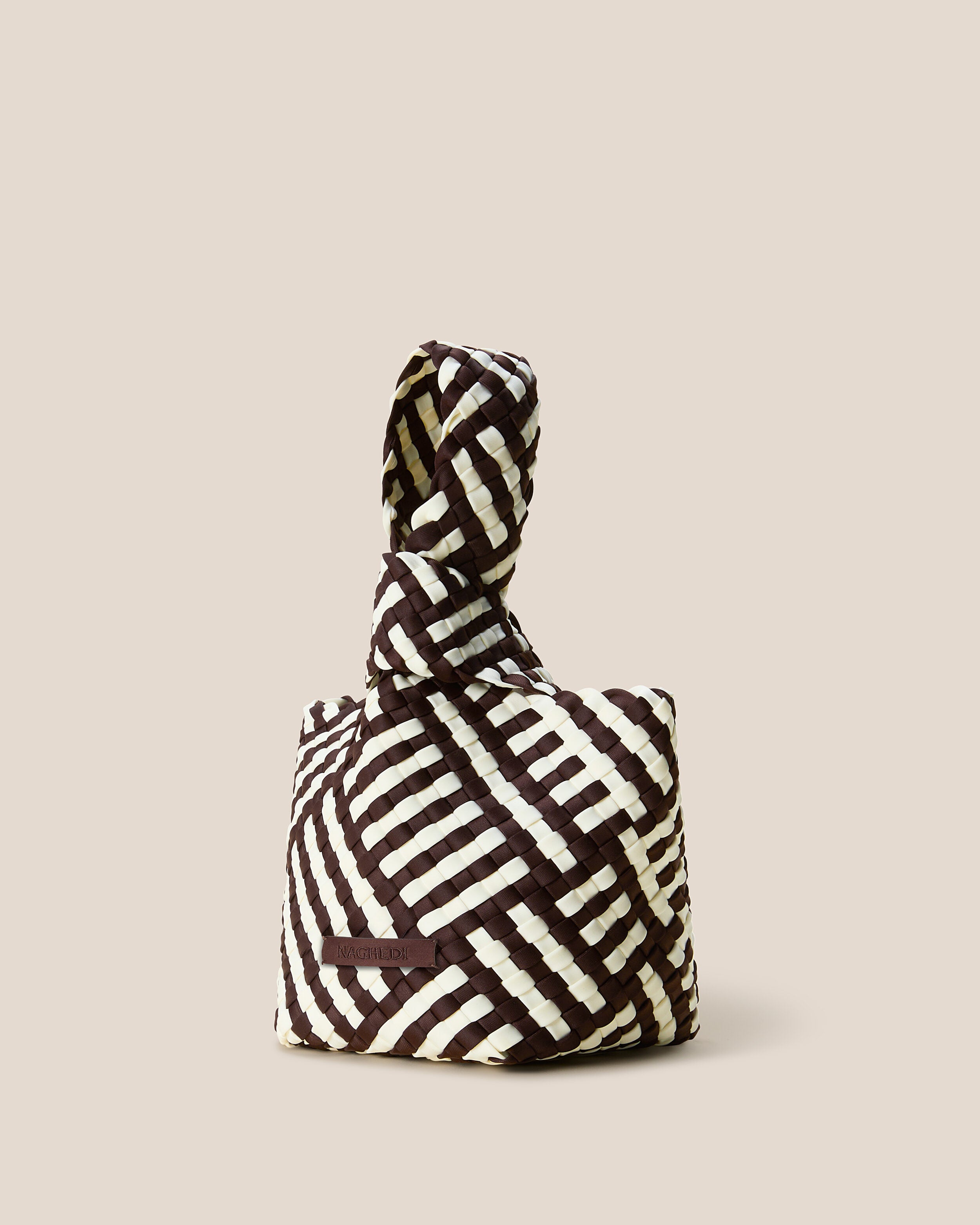 Kyoto Clutch in Roma shown from a side angle, highlighting its handwoven neoprene construction and secure slide-through loop closure.