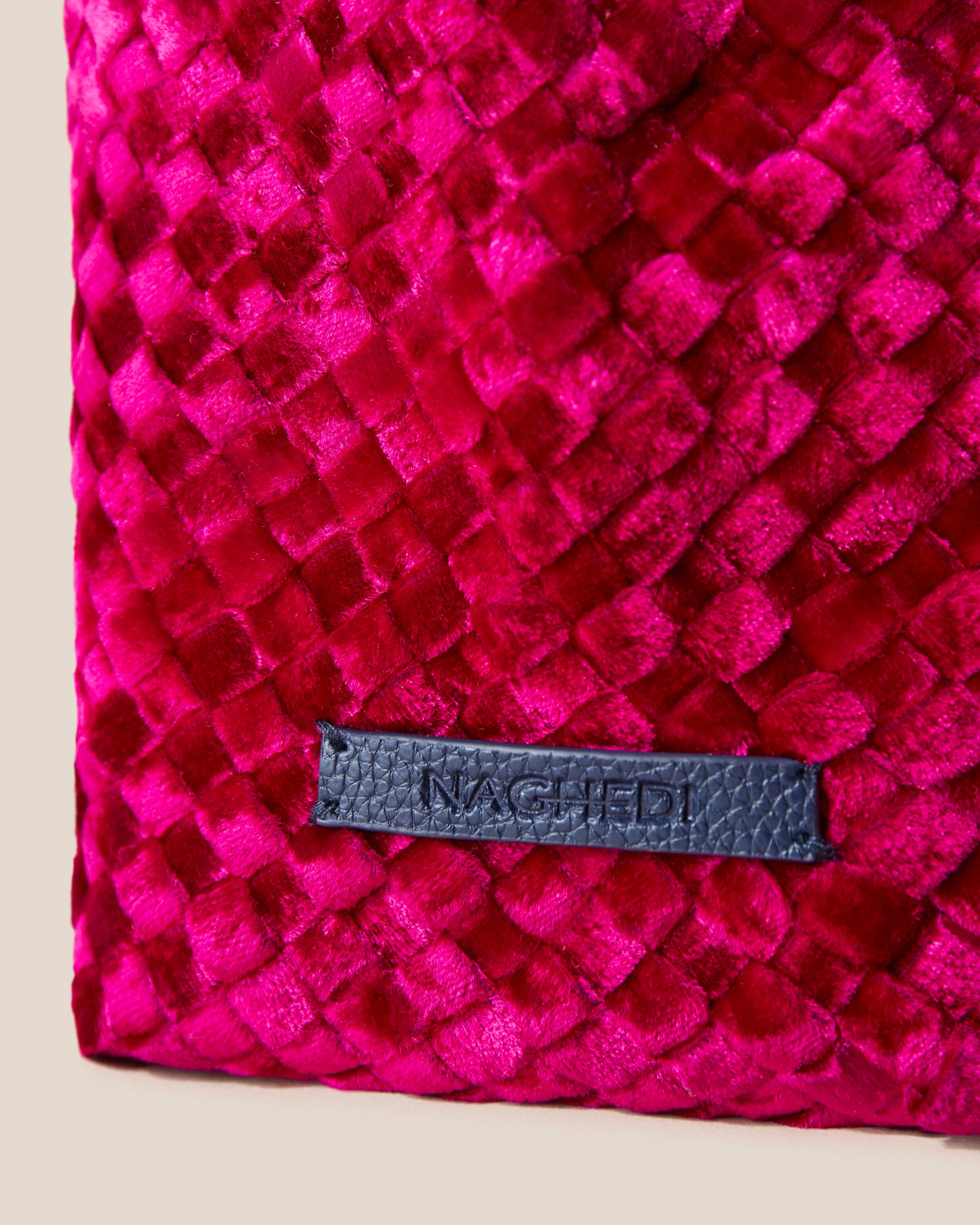 Close-up of stamped NAGHEDI logo on Kyoto Clutch in Crush.