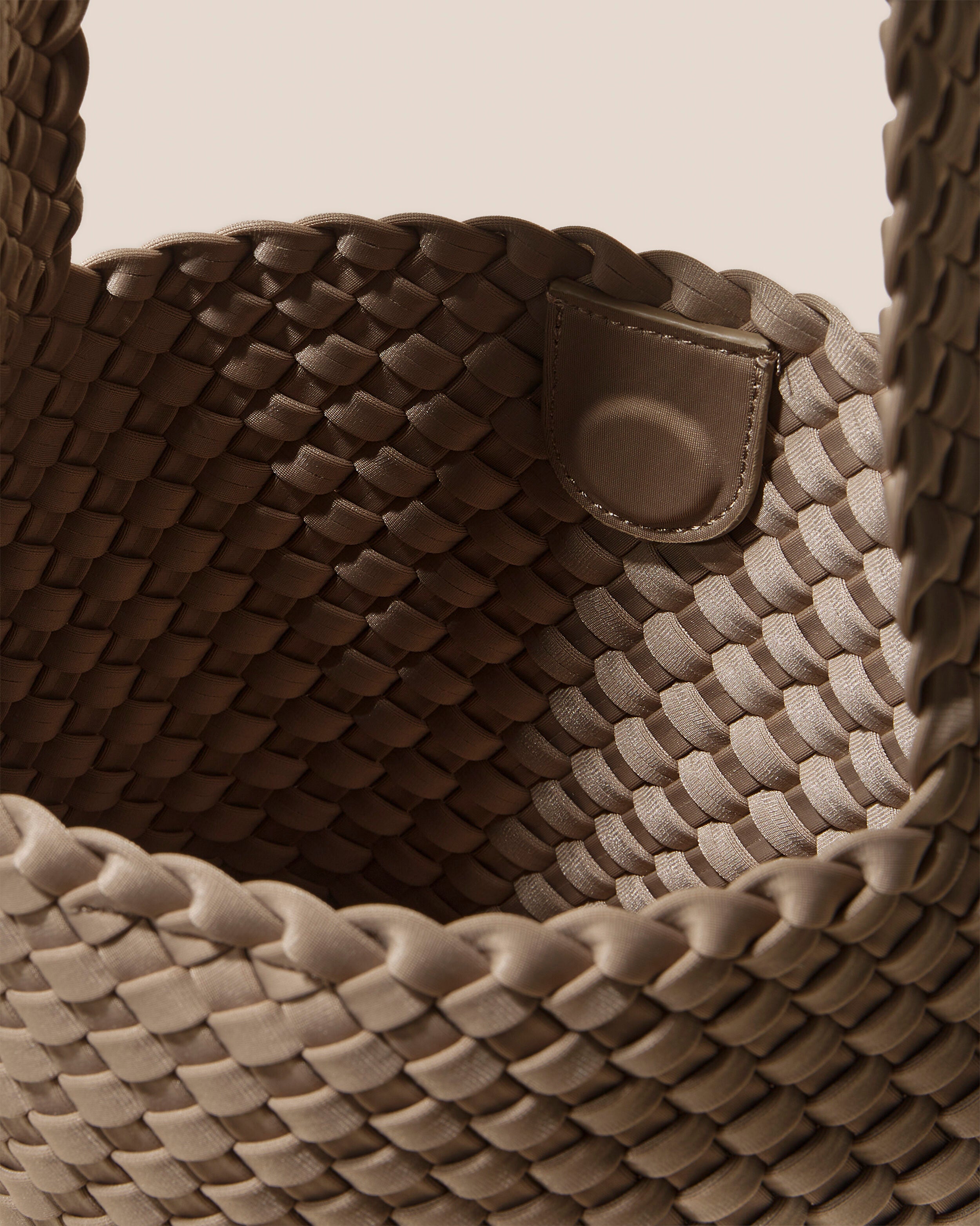 Interior close-up of Laguna Crossbody in Cashmere showing its open top with magnetic snap closure, and unlined interior.