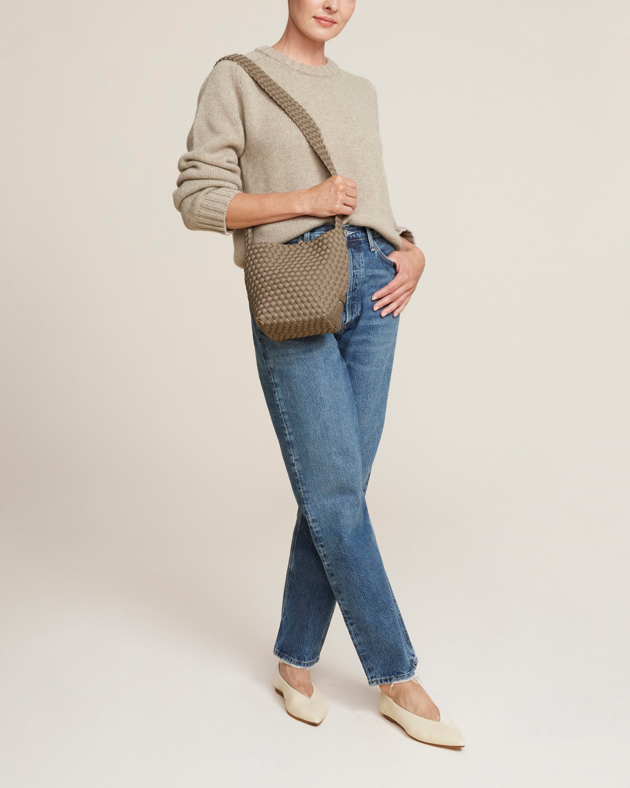 Laguna Crossbody in Cashmere shown on model to illustrate scale and soft silhouette.