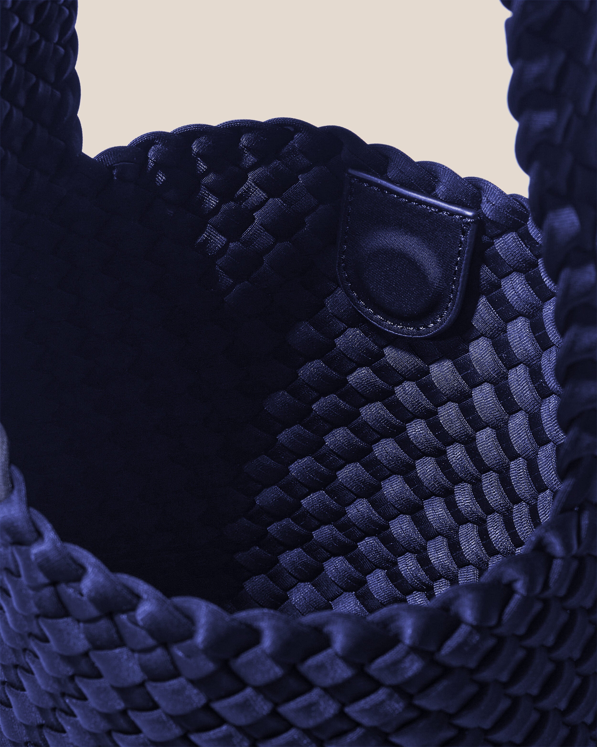 Interior close-up of Laguna Crossbody in Ink Blue showing its open top with magnetic snap closure, and unlined interior.