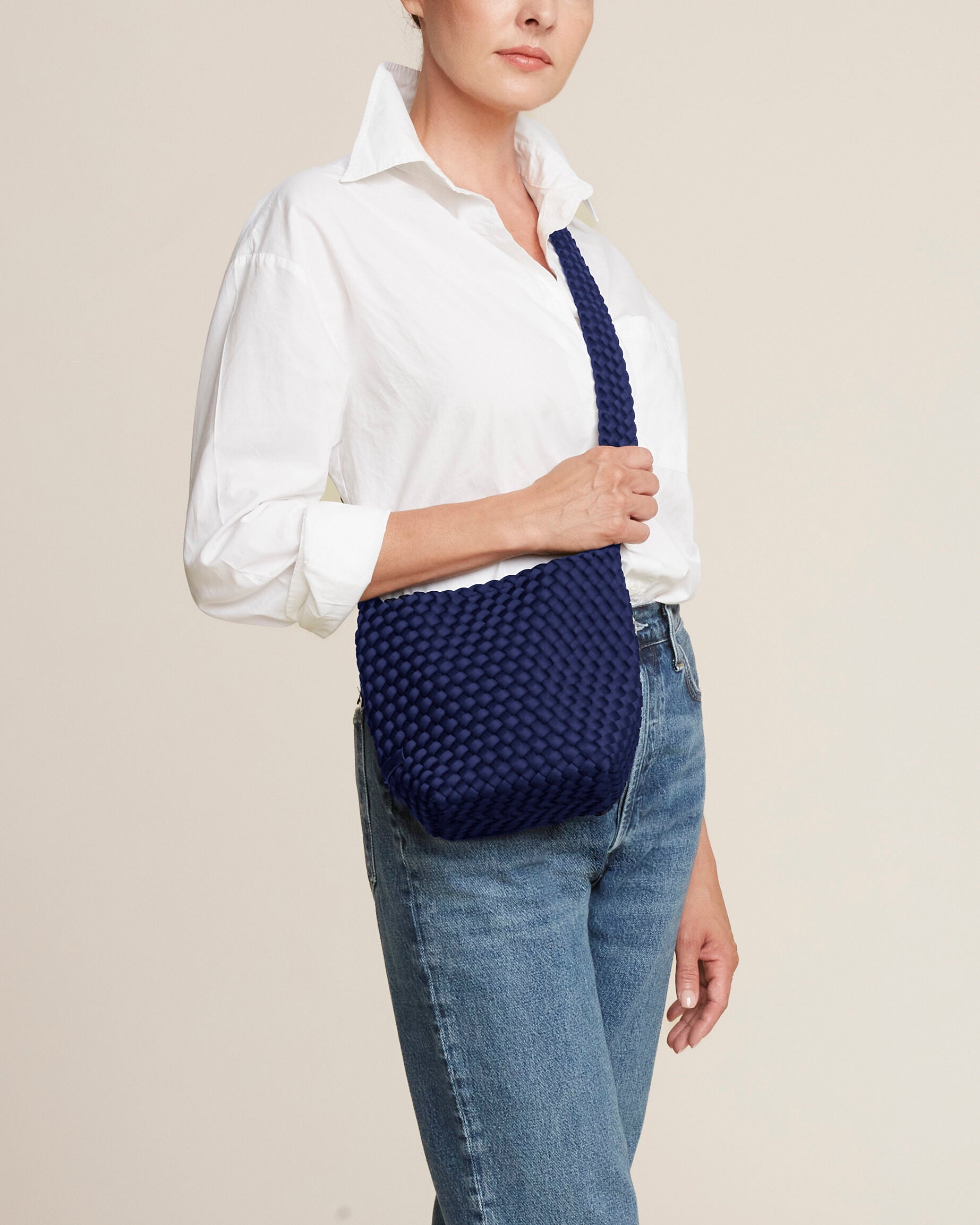 Laguna Crossbody in Ink Blue shown on model to illustrate scale and soft silhouette.