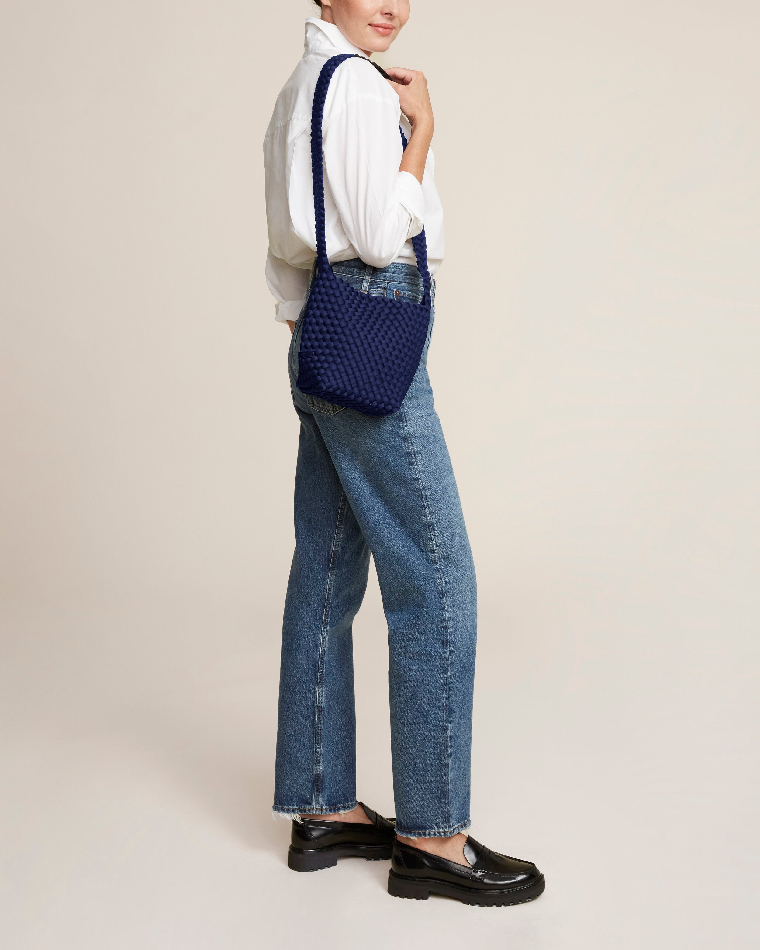 Laguna Crossbody in Ink Blue shown on model to illustrate scale and soft silhouette.