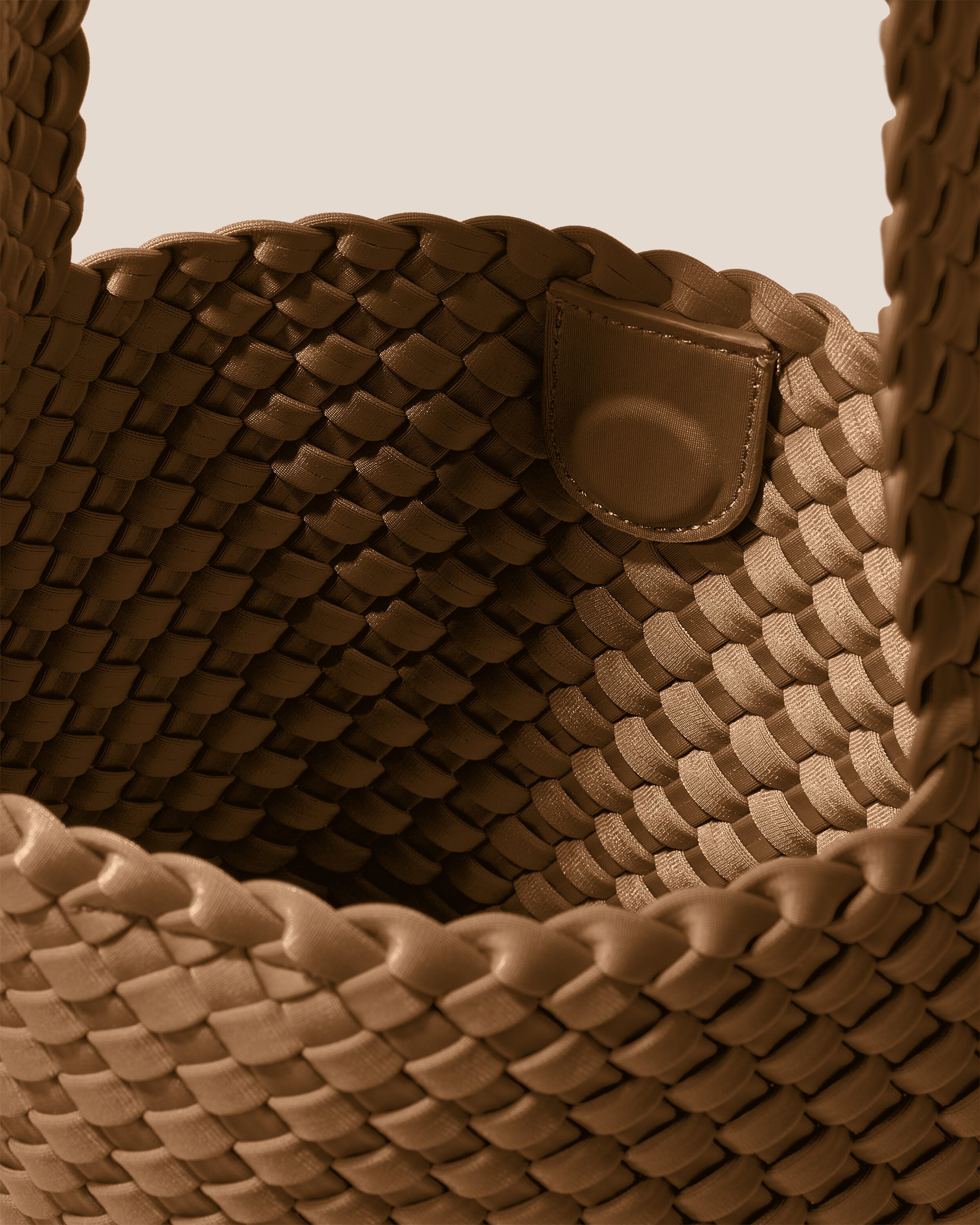 Interior close-up of Laguna Crossbody in Mink showing its open top with magnetic snap closure, and unlined interior.