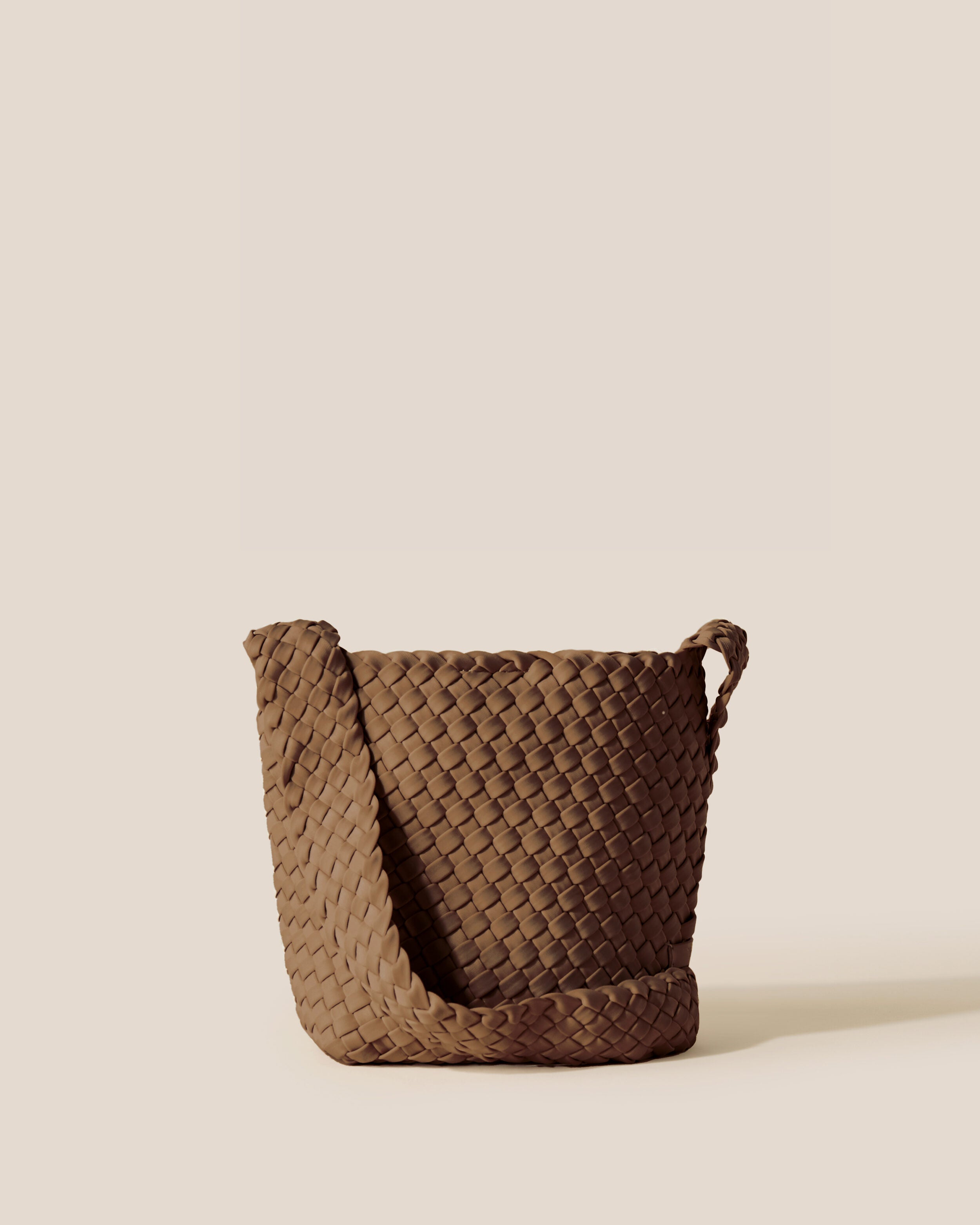 Laguna Crossbody in Mink, a brown tone, in handwoven neoprene, featuring an open top with magnetic snap closure, and handwoven crossbody strap lays comfortably flat.