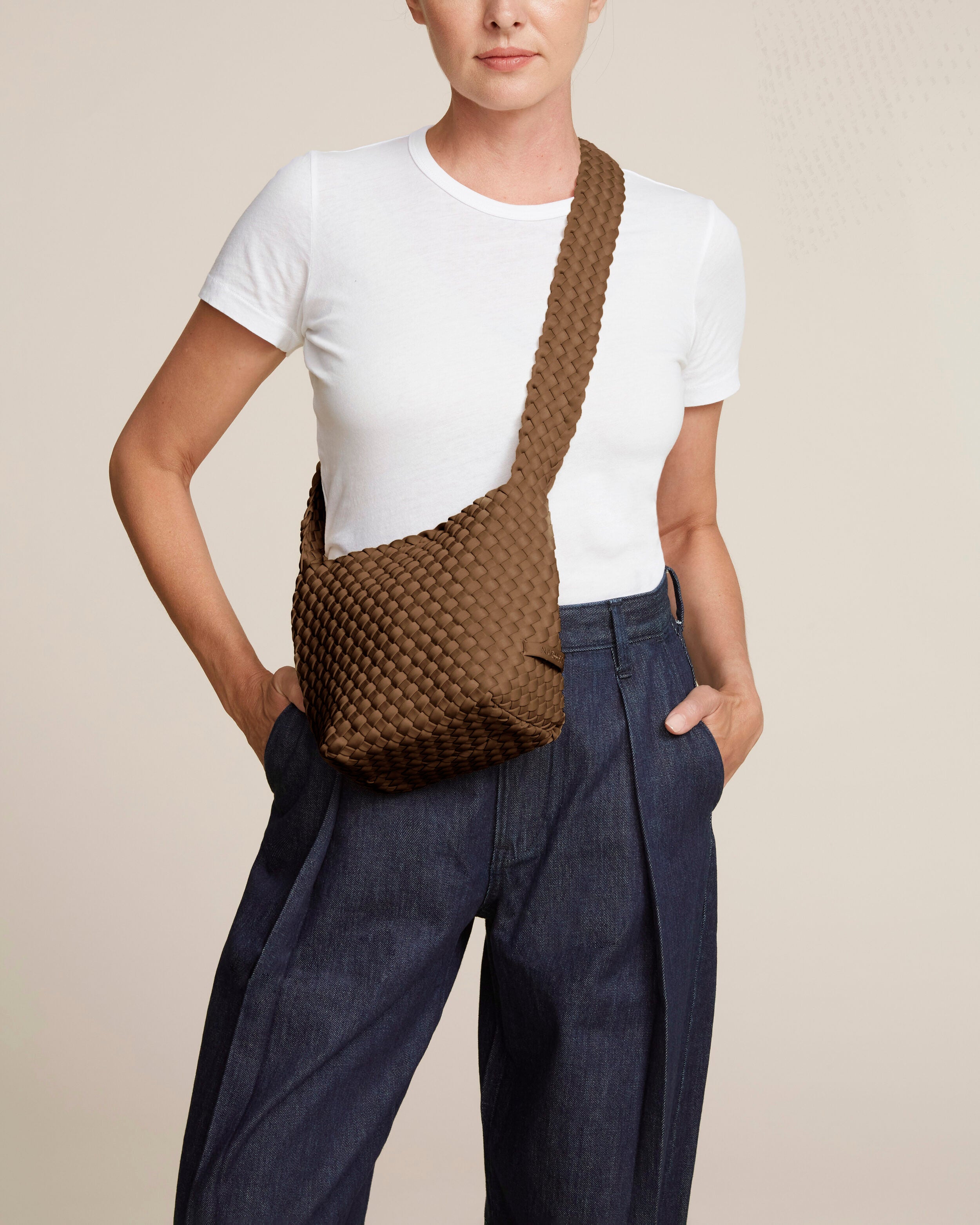 Laguna Crossbody in Mink shown on model to illustrate scale and soft silhouette.