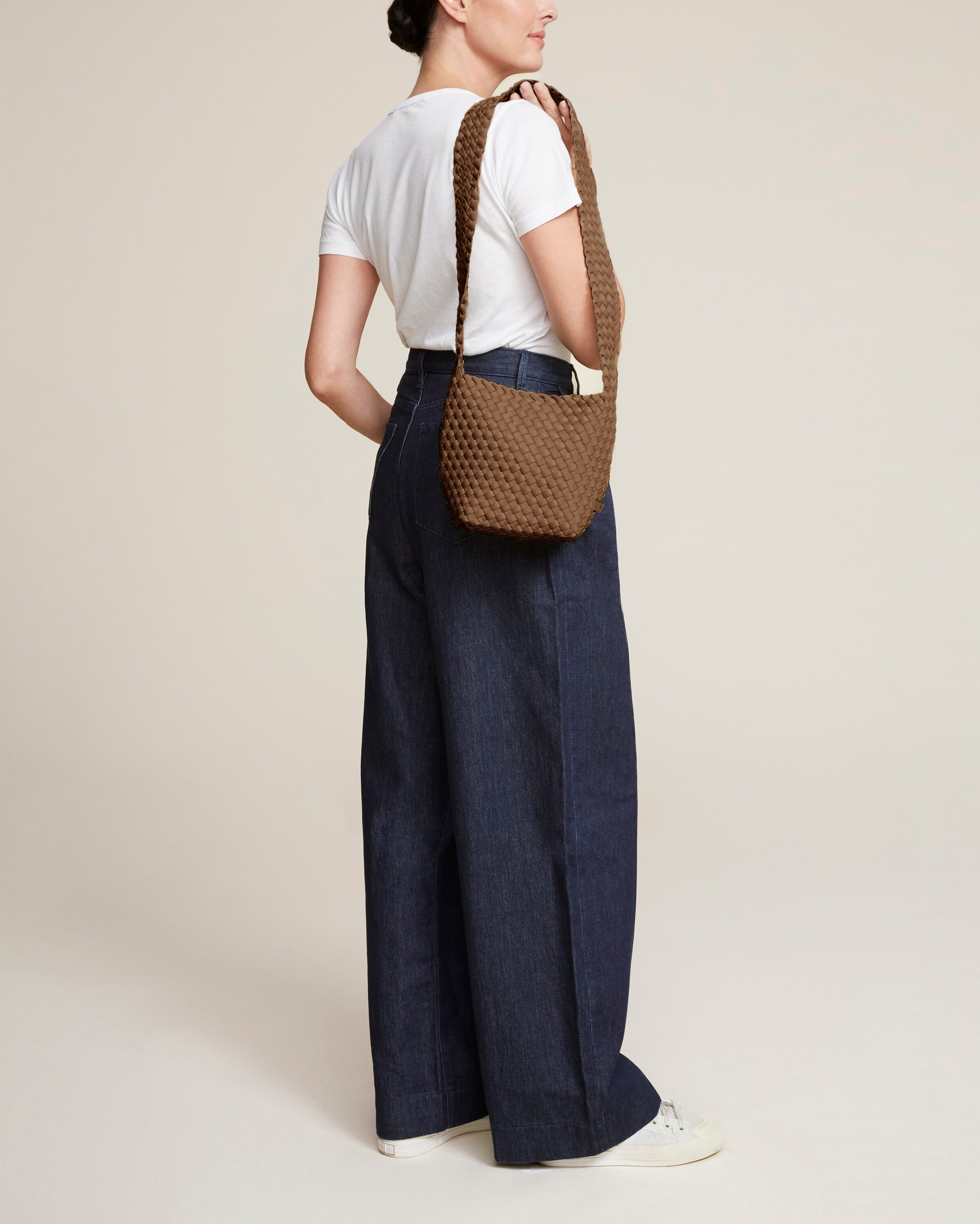 Laguna Crossbody in Mink shown on model to illustrate scale and soft silhouette.