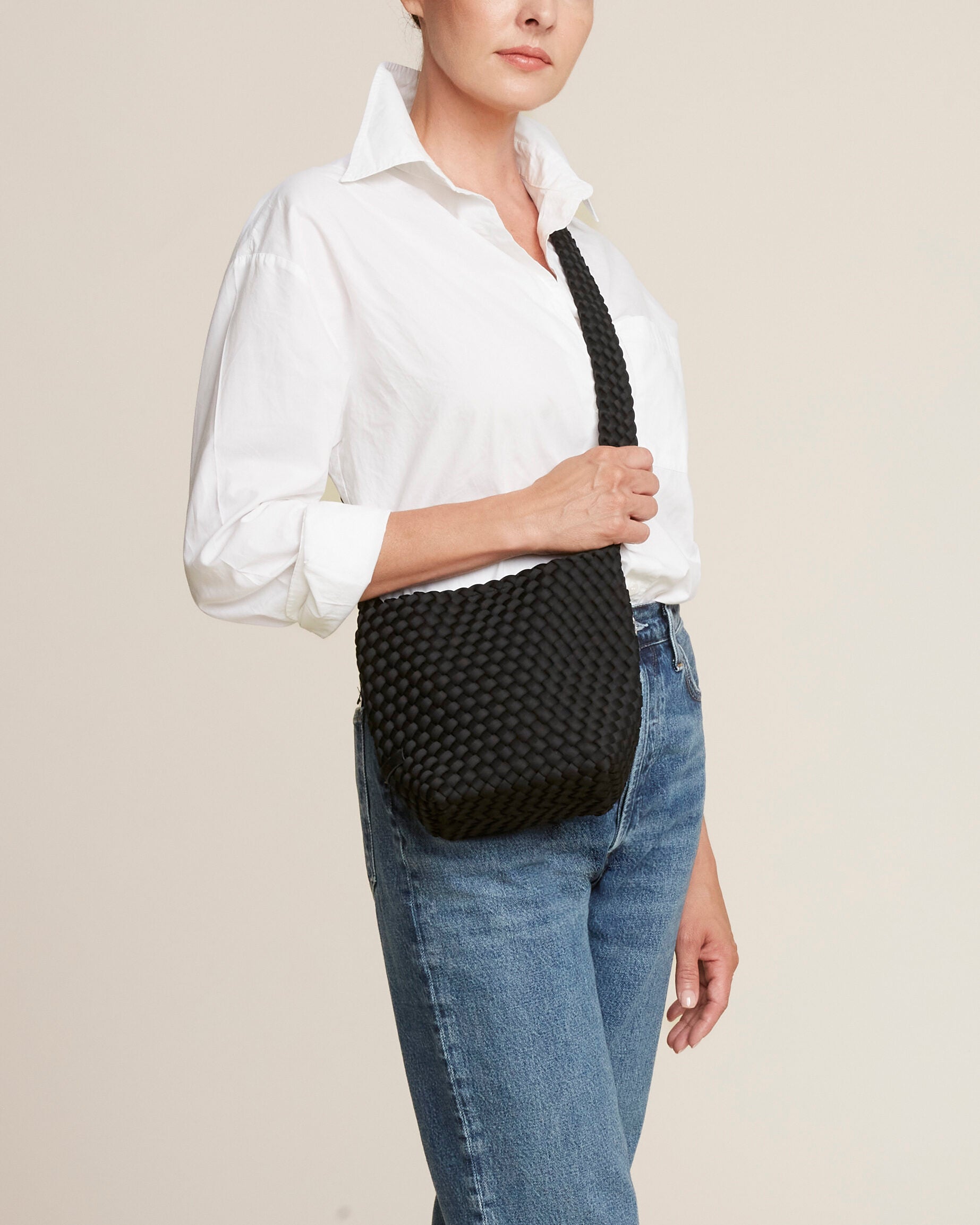 Laguna Crossbody in Onyx shown on model to illustrate scale and soft silhouette.