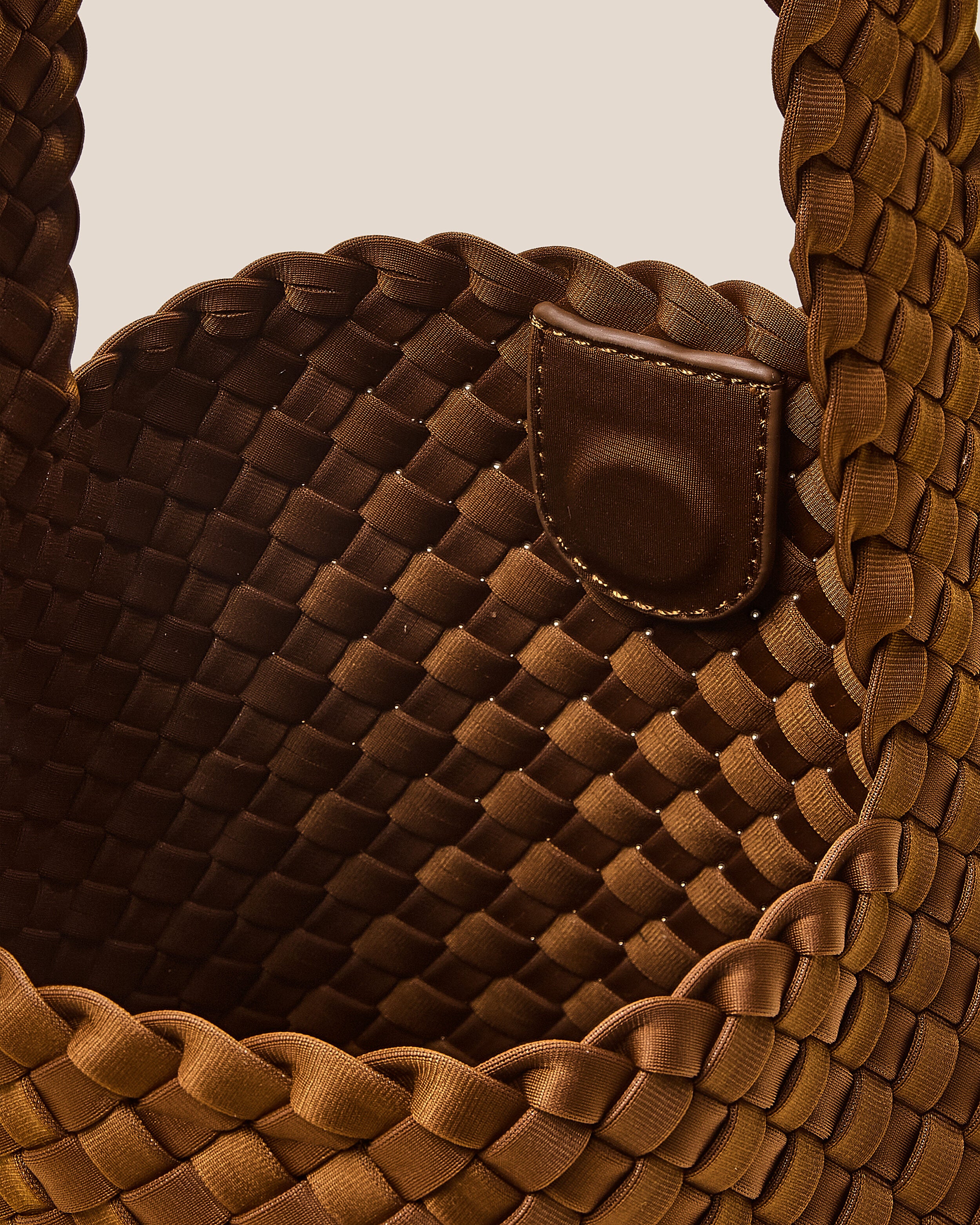 Interior close-up of Laguna Crossbody in Teak showing its open top with magnetic snap closure, and unlined interior.